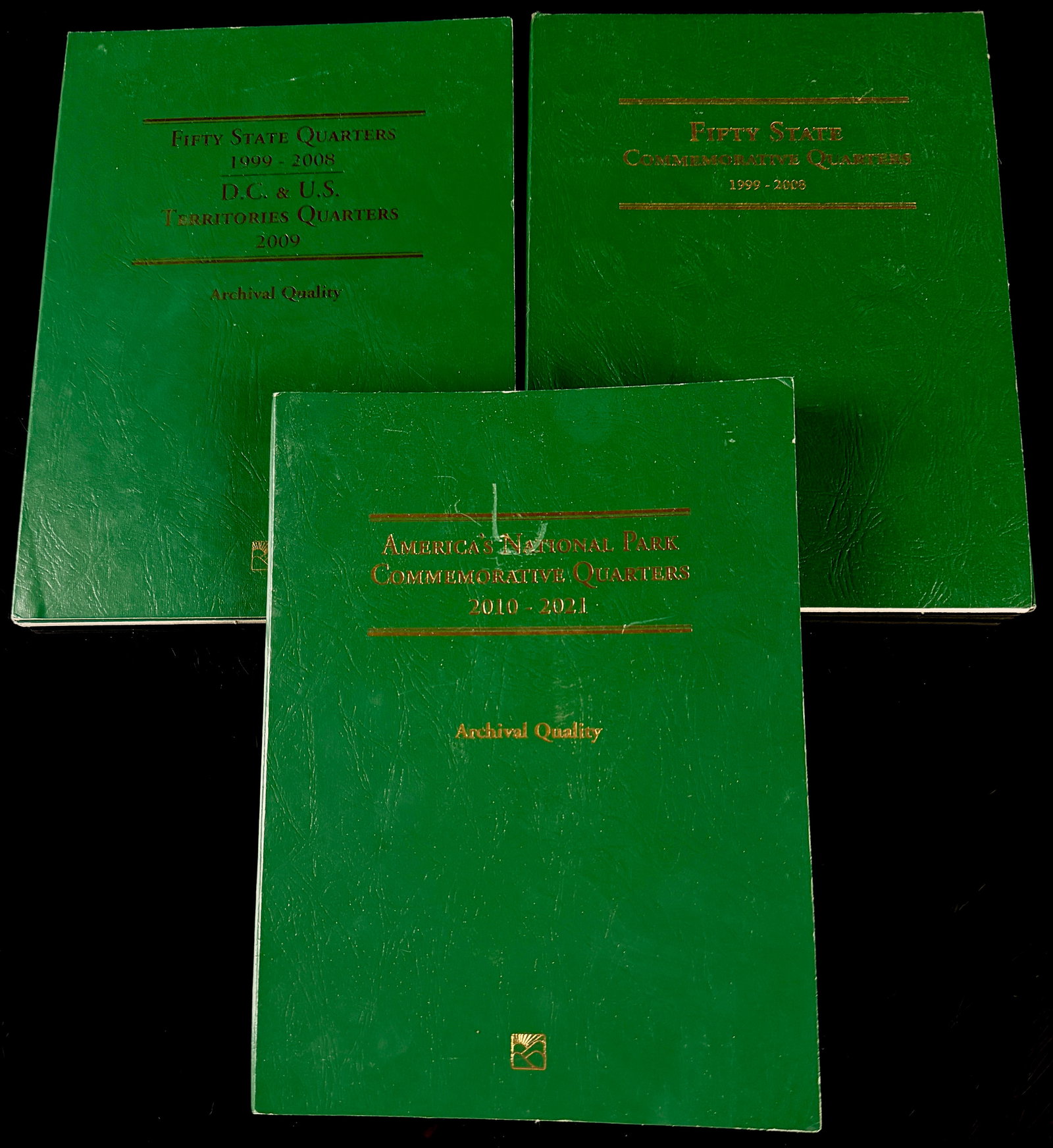 Three Littleton Coin Company Commemorative Quarter Albums: This collection consists of three Littleton Coin Company commemorative quarter albums. The group includes two folders for the Fifty State Quarters series (1999-2008), one of which also includes the D.