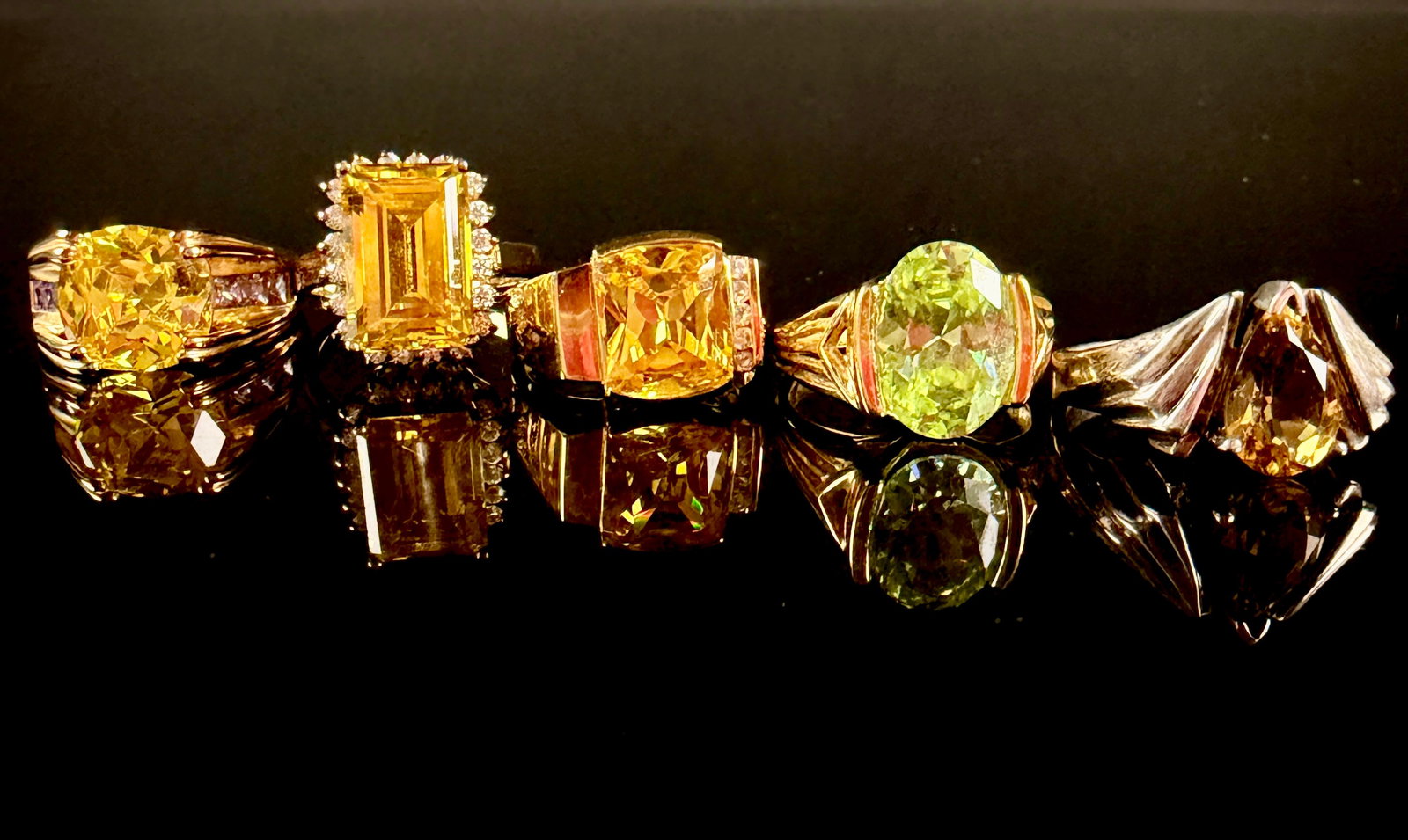 A Group of Sterling Silver and Lab-Created Yellow Gemstone Rings: A group of various cocktail and fashion rings featuring prominent center stones in a range of yellow and pale green hues, including lab-created yellow sapphire and citrine-style stones. The collection