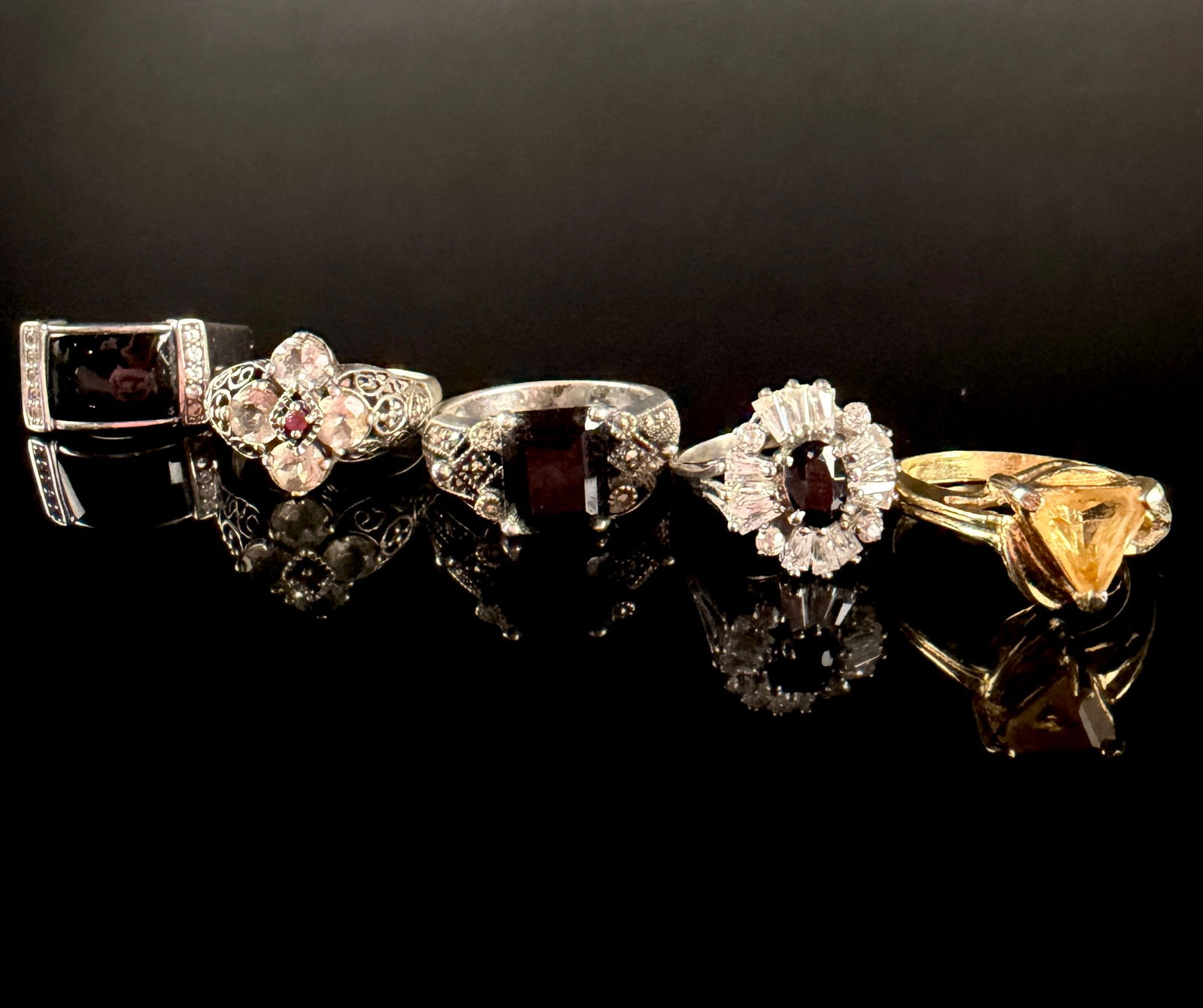 A Collection of Sterling Silver and Vermeil Gemstone Rings: This collection consists of several rings primarily constructed of sterling silver, including one example with a gold-toned vermeil finish. The assortment includes a wide band set with a rectangular b