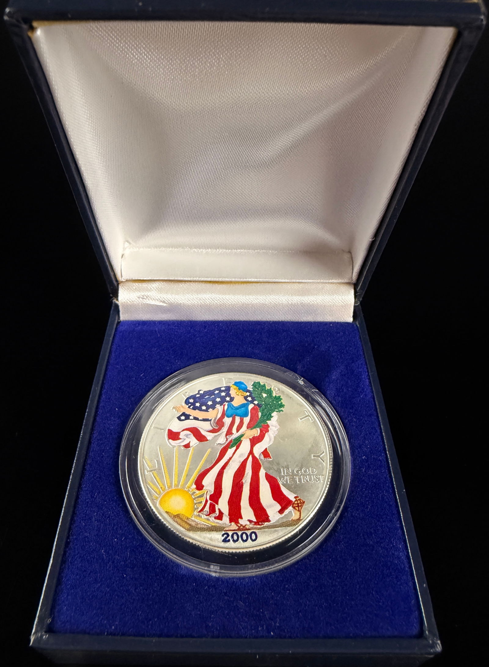 2000 Colorized American Eagle One Ounce Silver Dollar: A 2000 United States American Silver Eagle one-dollar bullion coin struck in .999 fine silver. The obverse features the Walking Liberty design with aftermarket polychrome colorization applied to the