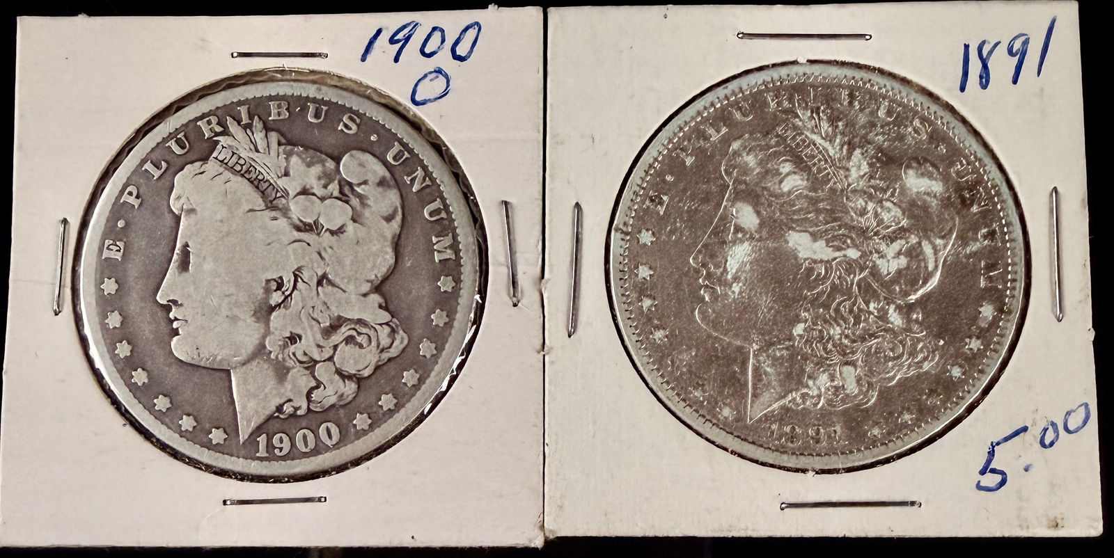 A Pair of United States Morgan Silver Dollars, 1891 and 1900-O: A pair of United States Morgan silver dollars comprising one 1891 and one 1900-O issue. 1900 coin was struck at the New Orleans Mint, identified by the O mint mark on the reverse above the