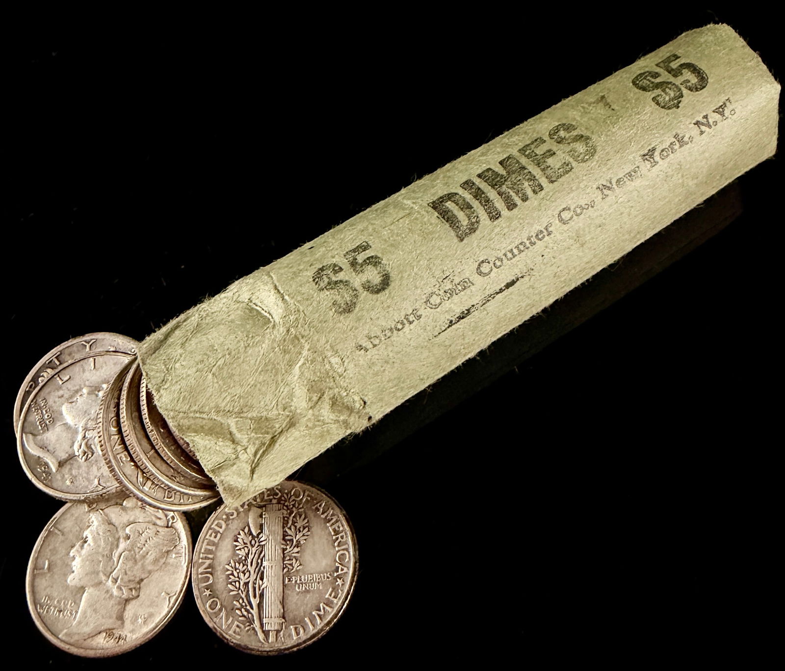 Lot of 50 United States 90 Percent Silver Mercury and Roosevelt Dimes with Vintage Wrapper: This collection features an assortment of United States 90 percent silver dimes, primarily consisting of the Winged Liberty Head design, commonly referred to as Mercury dimes, alongside early