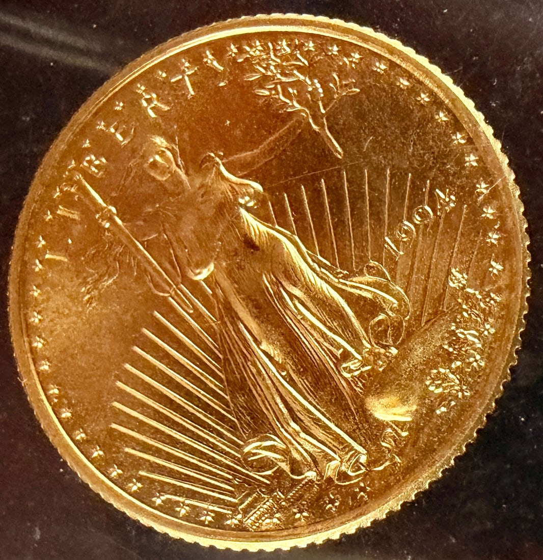 1994 United States 1/10 Ounce American Gold Eagle Five Dollar Coin: A 1994 United States American Gold Eagle bullion coin. The specimen is struck in 1/10 ounce of fine gold. The obverse features the Augustus Saint-Gaudens design of Lady Liberty walking forward with a