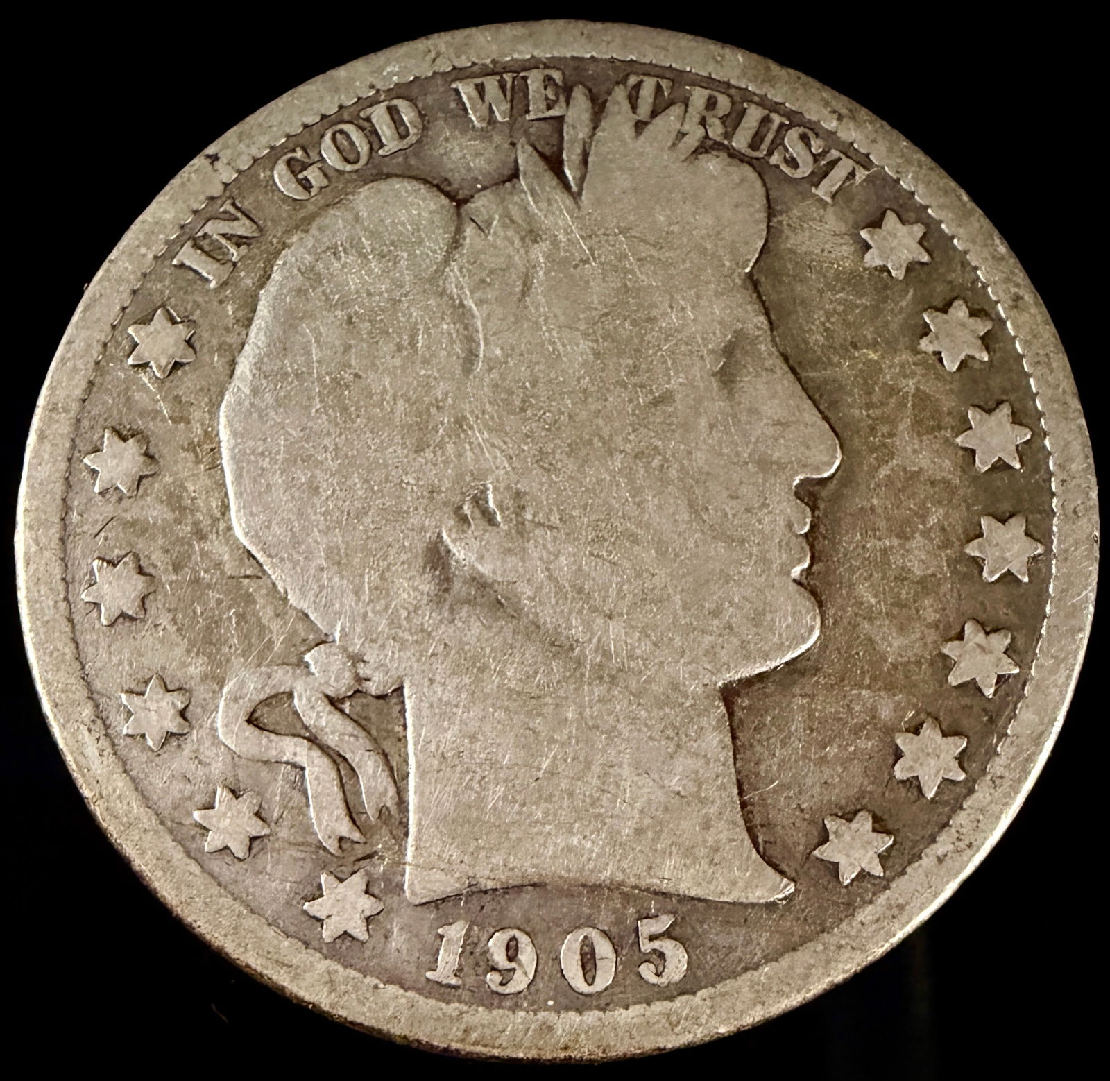 1905-S Barber Half Dollar Silver Coin: A United States 1905-S Barber Half Dollar struck in 90 percent silver at the San Francisco Mint. The obverse depicts the right-facing profile of Liberty wearing a laurel wreath and Phrygian cap, with