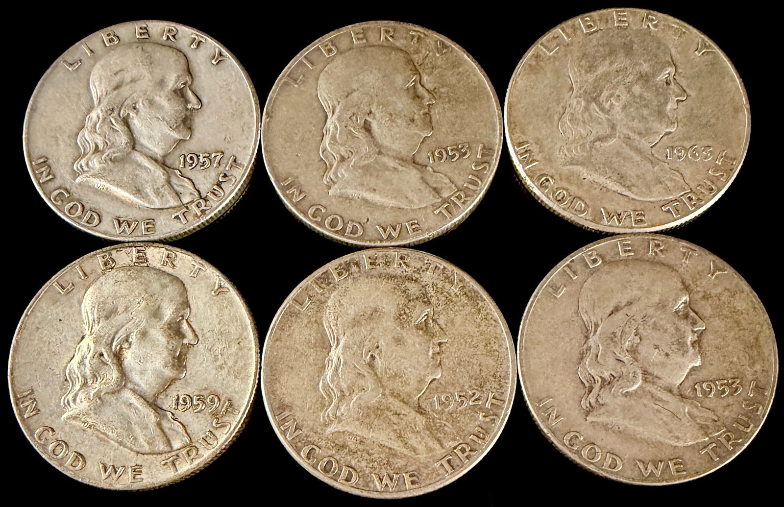 A Collection of United States Benjamin Franklin Silver Half Dollars: A collection of United States half dollar coins struck in 90 percent silver. The obverse of each coin features the profile portrait of Benjamin Franklin as designed by John R. Sinnock, accompanied by