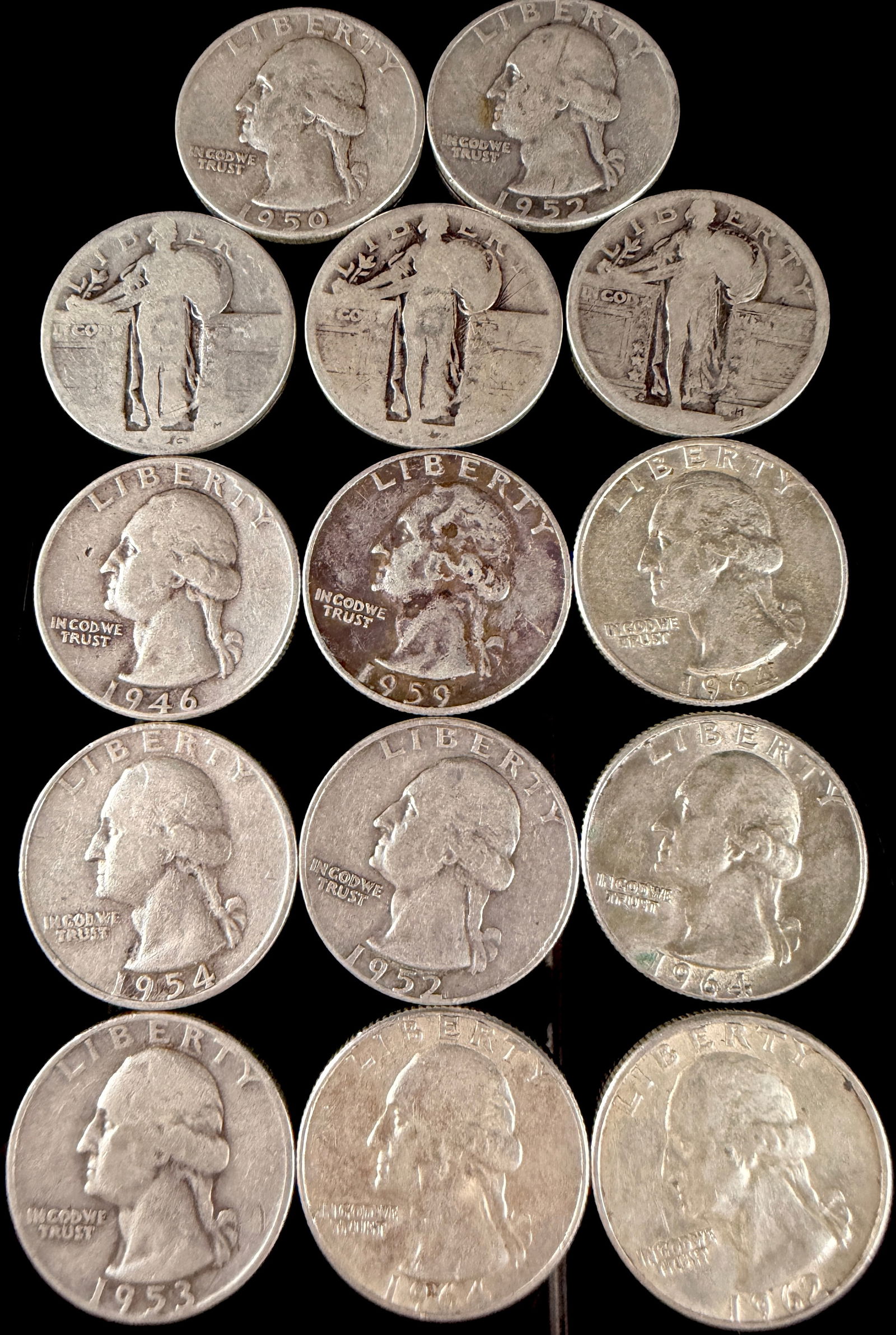 A Collection of United States Standing Liberty and Washington Silver Quarters: A collection of United States silver quarter dollar coins comprising both Standing Liberty and Washington designs. These coins are struck in 90 percent silver. The Washington quarters include various
