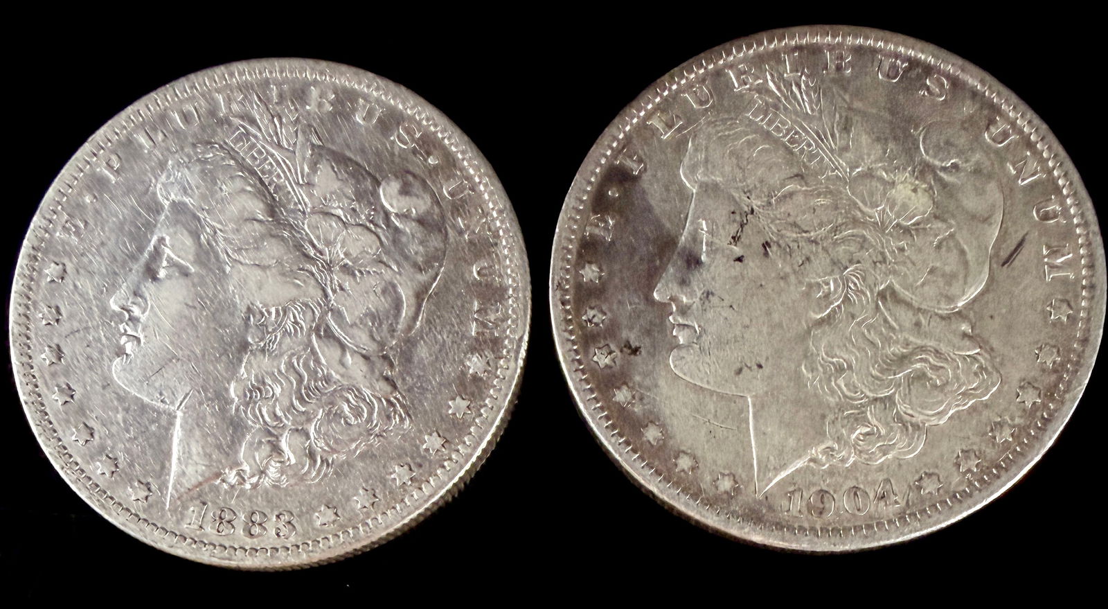 A Pair of United States Morgan Silver Dollars 1883 S and 1904 O (1 of 7)
