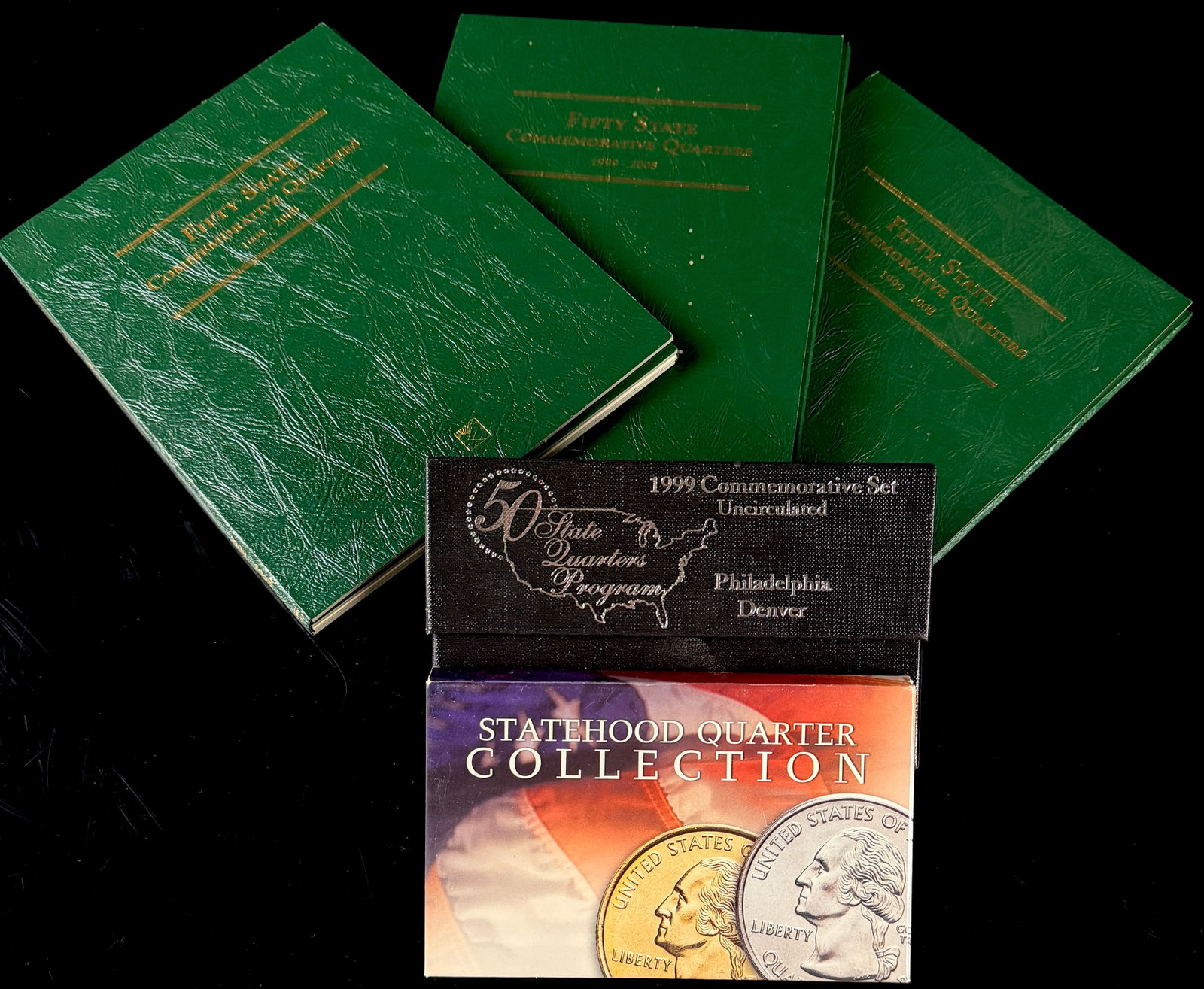 A Collection of Littleton Coin Company 50 State Quarters Program Albums and Sets: A collection of United States 50 State Quarters Program numismatic materials produced by the Littleton Coin Company. The group includes three green three-ring binder collector albums titled Fifty Stat