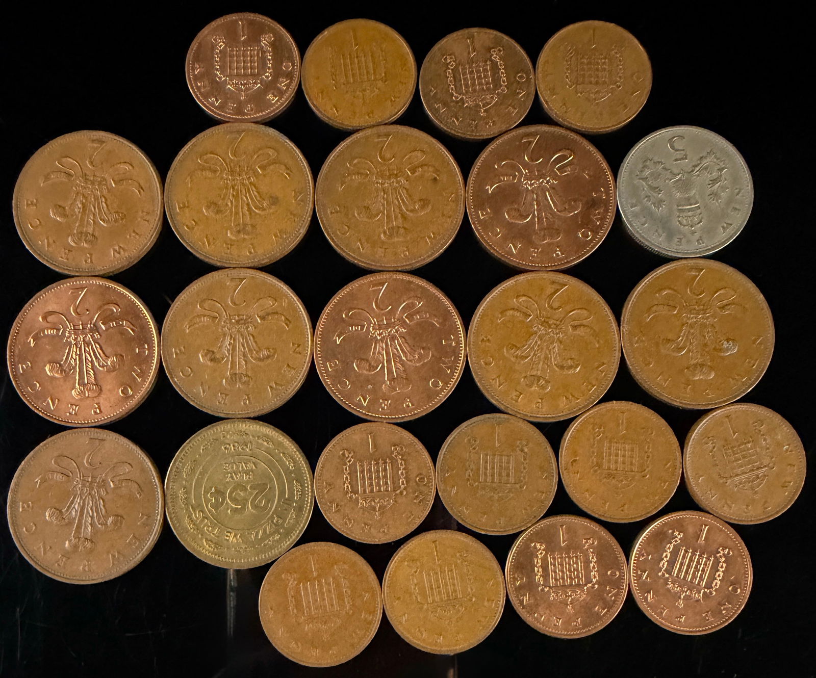 A Collection of Great Britain Decimal Coins and Token: A collection of British decimal currency and a promotional arcade token, primarily dating from the late 1960s through the late 1980s. The group includes multiple bronze one penny and two pence coins f