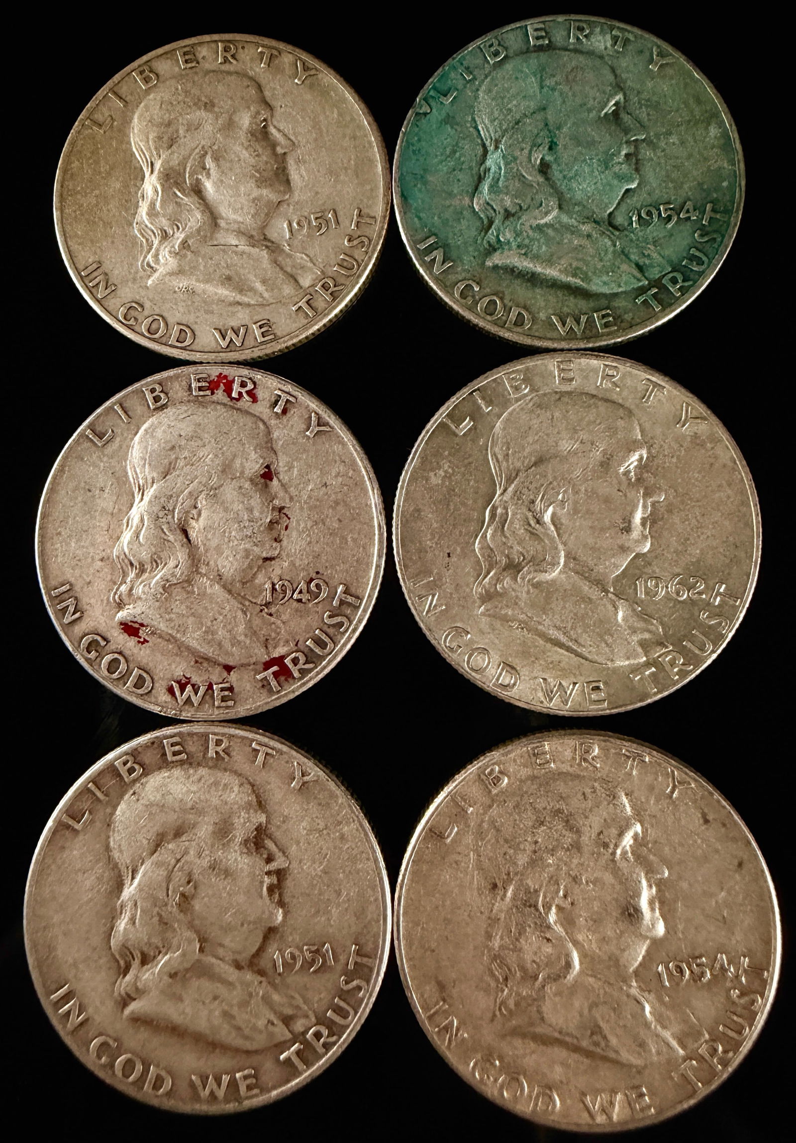 A Group of United States Benjamin Franklin Silver Half Dollars: A group of United States Benjamin Franklin half dollars minted in 90% silver. The obverse of each coin features a profile portrait of Benjamin Franklin facing right, with the inscriptions LIBERTY abov
