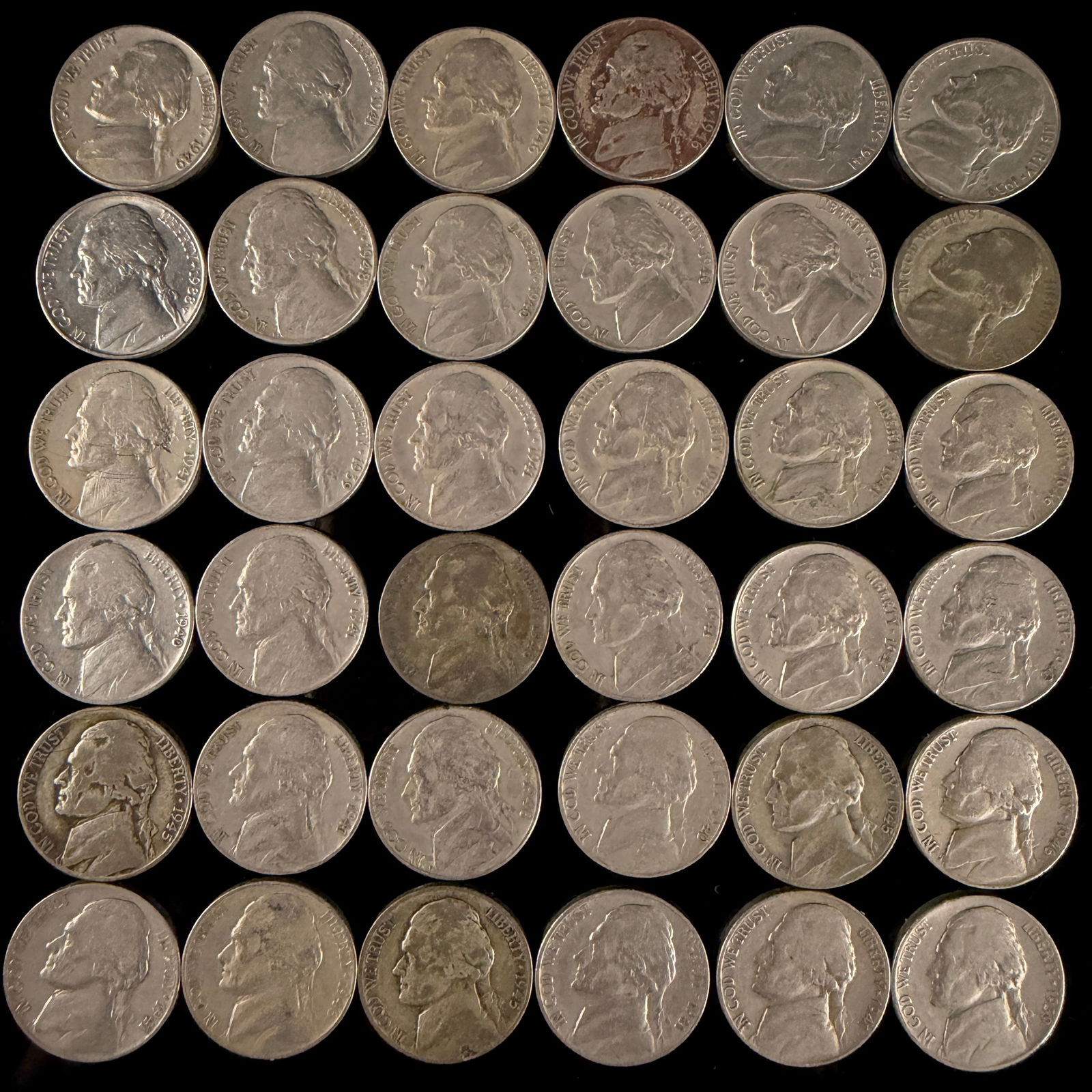A Collection of United States Jefferson Nickels: A collection of United States Jefferson five-cent coins dating from the late 1930s through the late 1940s. The obverse of each coin features a profile portrait of Thomas Jefferson facing left, accompa