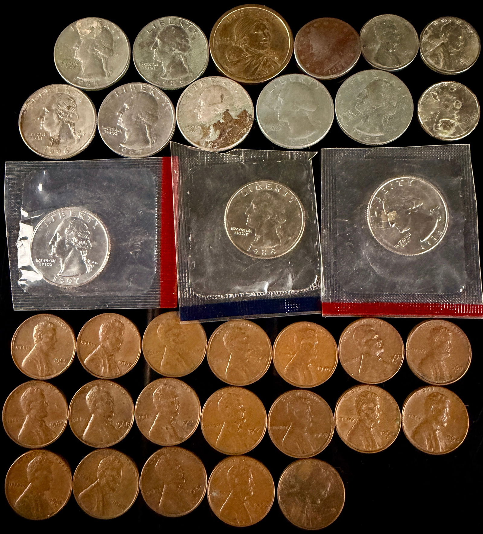 A Collection of United States Lincoln Cents, Washington Quarters, and a Sacagawea Dollar (1 of 11)