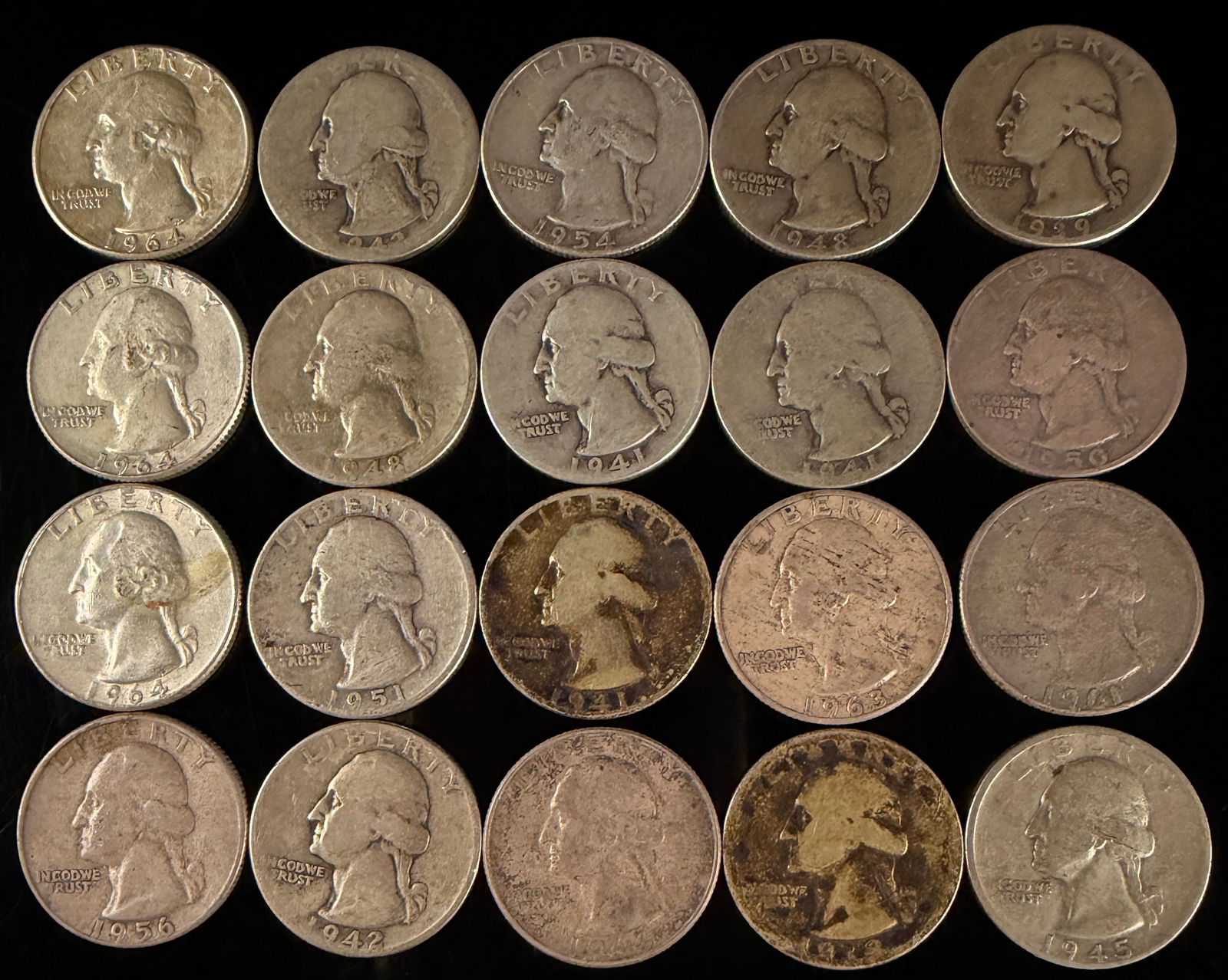 A Collection of United States Washington Quarters: A collection of United States Washington quarters dating from the mid-20th century. The obverse of each coin features the portrait of George Washington facing left, with the inscriptions LIBERTY above