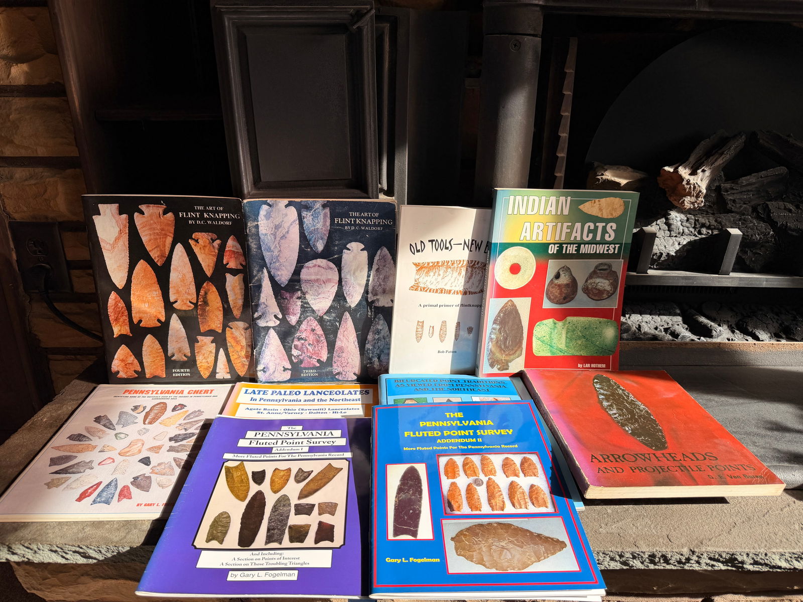 A Collection of North American Paleo-Indian Artifact Identification and Value Guides: A collection of softcover reference books and identification guides focused on North American archaeology, Native American stone artifacts, and the craft of flint knapping. The group includes several