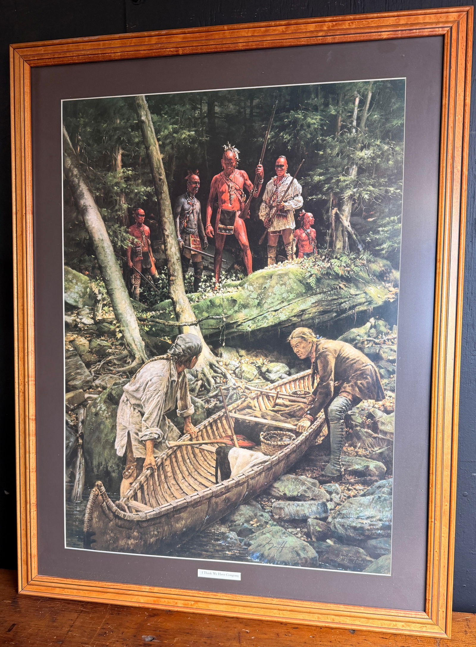 Robert Griffing I Think We Have Company Limited Edition Print: This offset lithographic print by Robert Griffing is titled I Think We Have Company. The work depicts a historical scene of Native American figures in a wooded landscape observing two frontiersmen wit