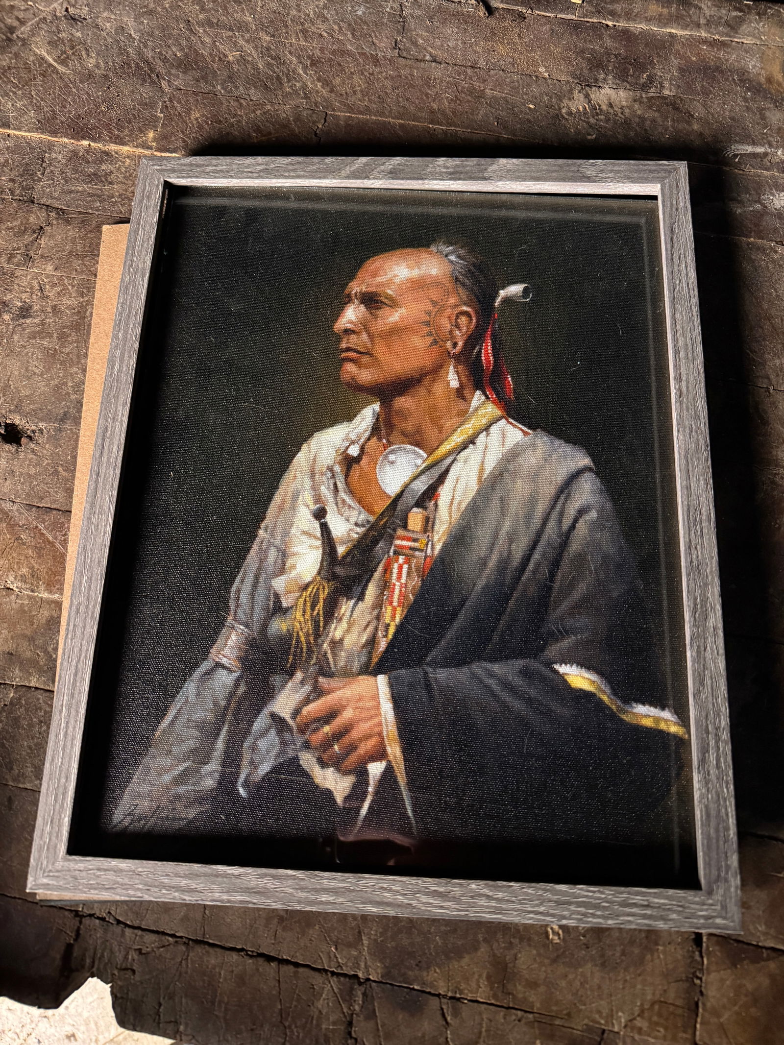 Robert Griffing Signed Canvas Giclee Print of an Indigenous American Man: A canvas giclee print by artist Robert Griffing depicting a profile portrait of an Indigenous American man in 18th-century Eastern Woodlands attire. The subject is rendered with facial markings and is