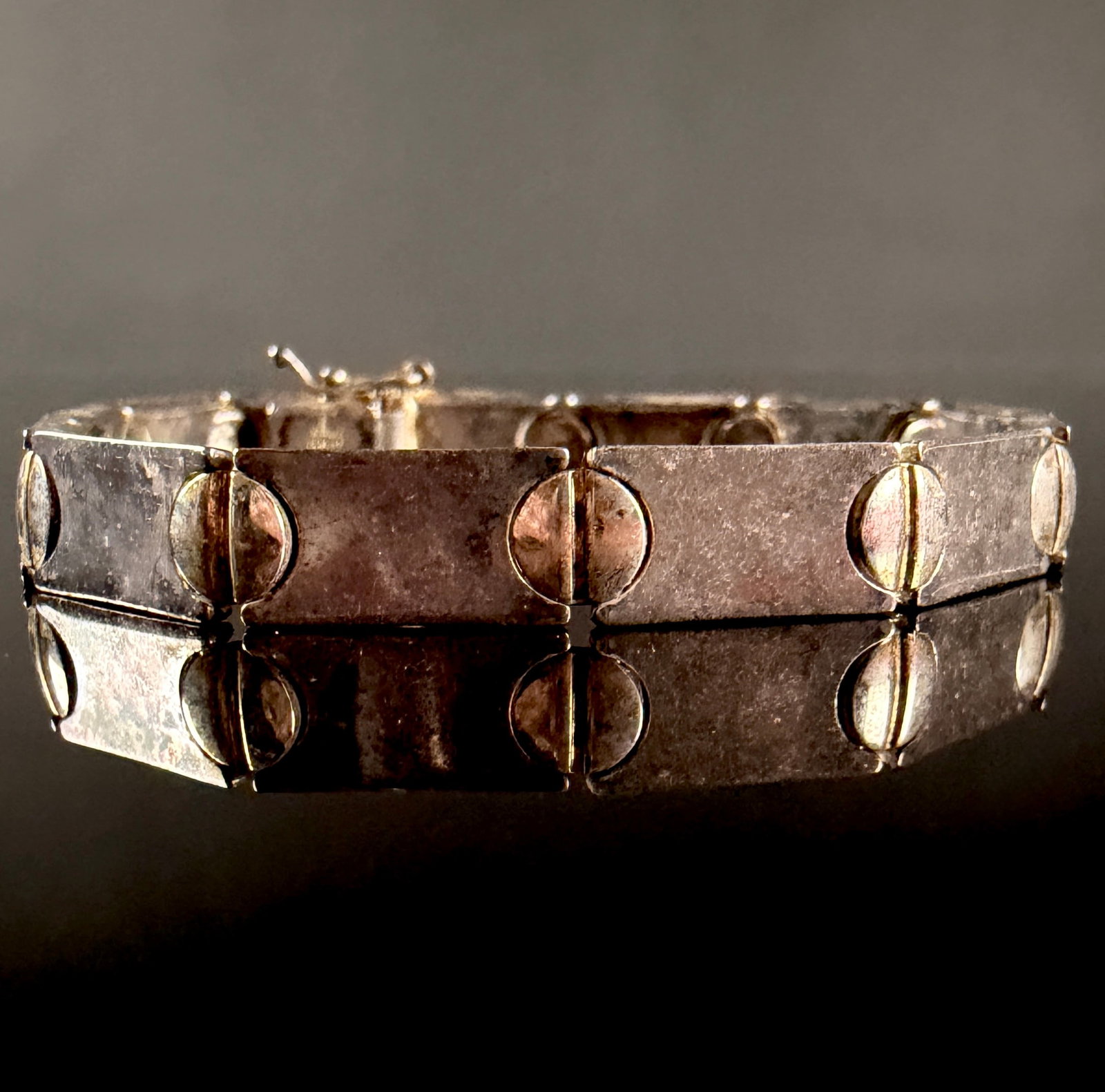 Milor Italian Sterling Silver Vermeil Link Bracelet: This link bracelet is manufactured by Milor and originates from Italy. The piece is constructed from sterling silver with a gold-tone vermeil finish. It features twelve rectangular flat-bar links conn