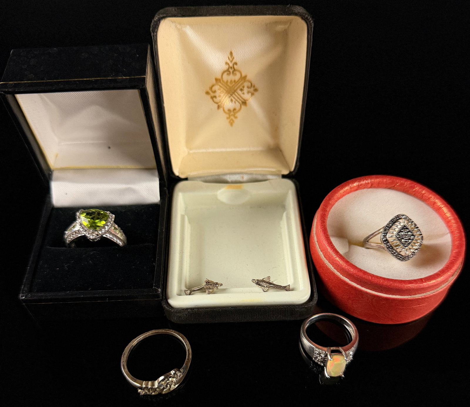 A Collection of Sterling Silver Jewelry Including Gemstone and Sentiment Rings: This collection of sterling silver jewelry consists of several rings and a pair of stud earrings, all featuring 925 hallmarks. The group includes a statement ring centered with a trillion-cut green st