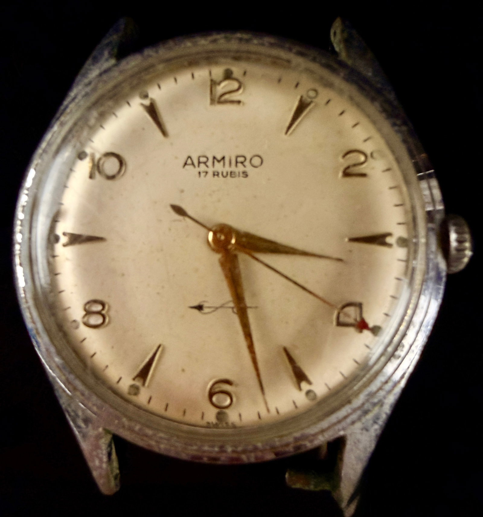 Armiro 17 Rubis Manual Wind Swiss Wristwatch, circa 1950s: A mid-20th-century Swiss-made Armiro manual wind wristwatch. Watch Runs, The cream-colored dial features applied gold-tone Arabic numerals at the even hours and dart-shaped indices at the odd hours. I