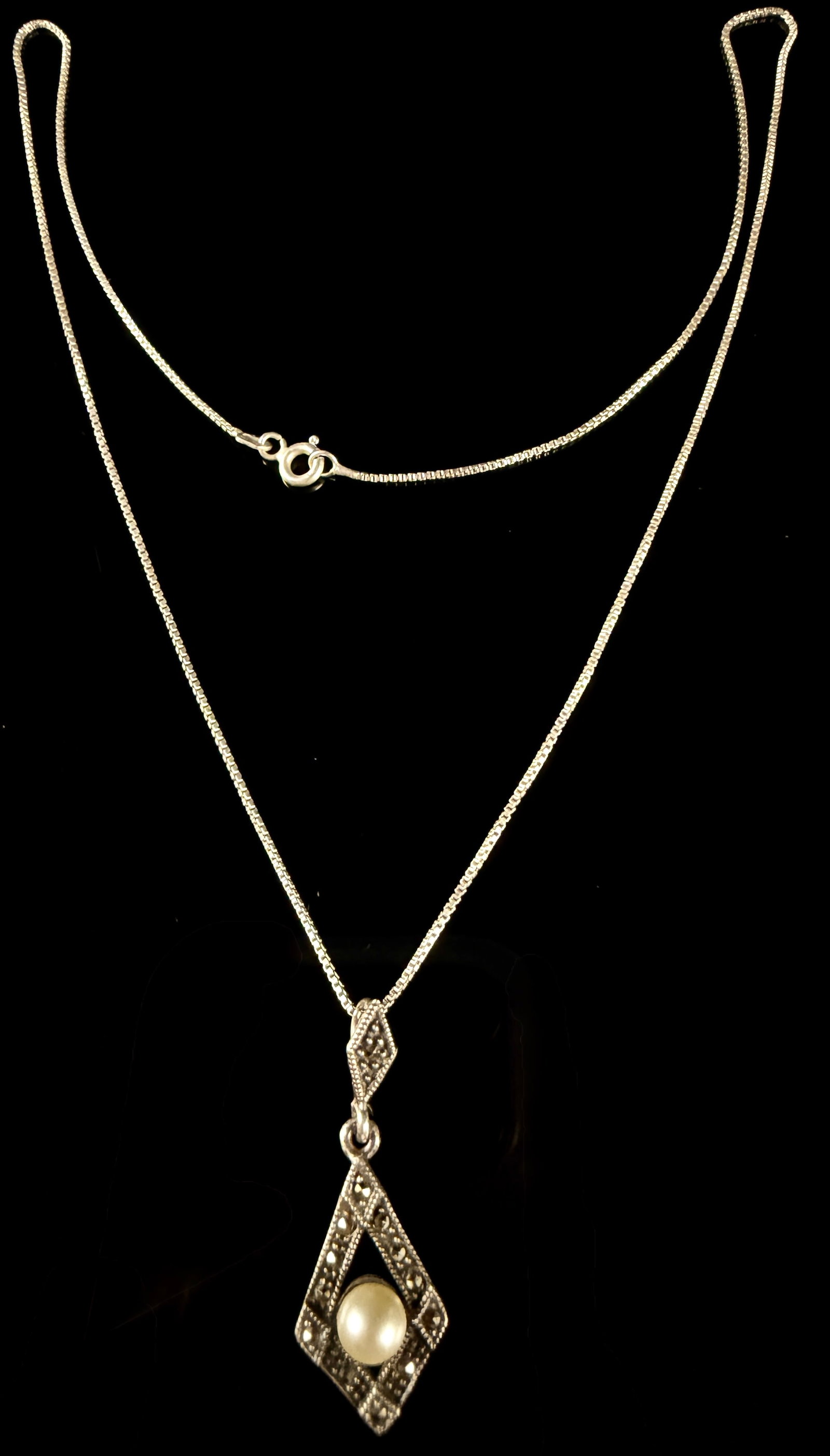 Art Deco Style Sterling Silver Marcasite and Pearl Pendant Necklace by HAN: This Art Deco style necklace features an articulated pendant composed of two geometric lozenge-shaped components in sterling silver. The design includes milgrain edging and is set with multiple rose-c