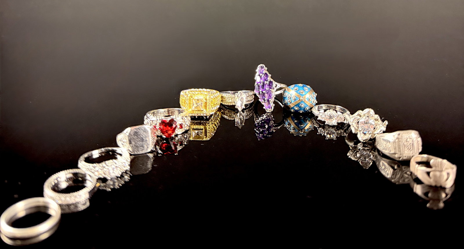 A Collection of Sterling Silver and Fashion Cocktail Rings: This collection features a variety of sterling silver and fashion rings in diverse styles. The lot includes a sterling silver Claddagh ring marked MADE IN IRELAND and STERLING with a sunburst hallmark