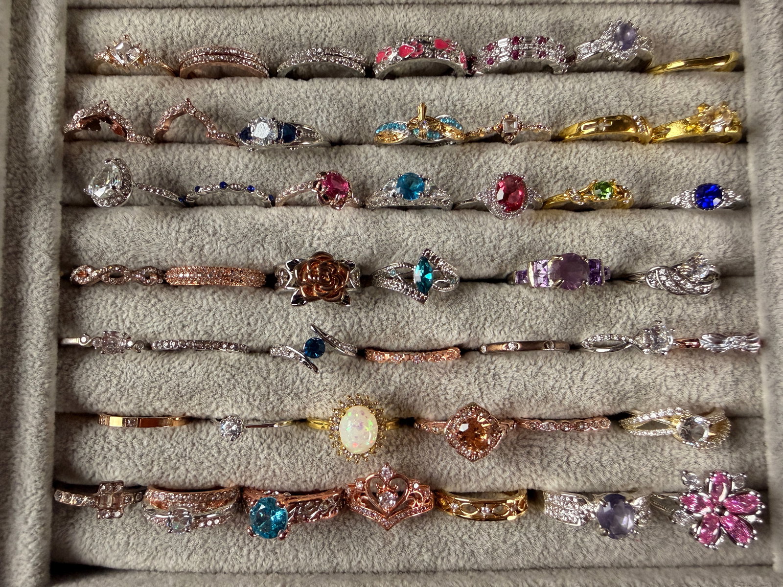 An Assortment of Contemporary Fashion and Costume Rings: A large assortment of contemporary fashion and costume rings in a wide variety of styles and finishes. The collection includes engagement-style solitaires, multi-stone bands, cocktail rings, eternity-