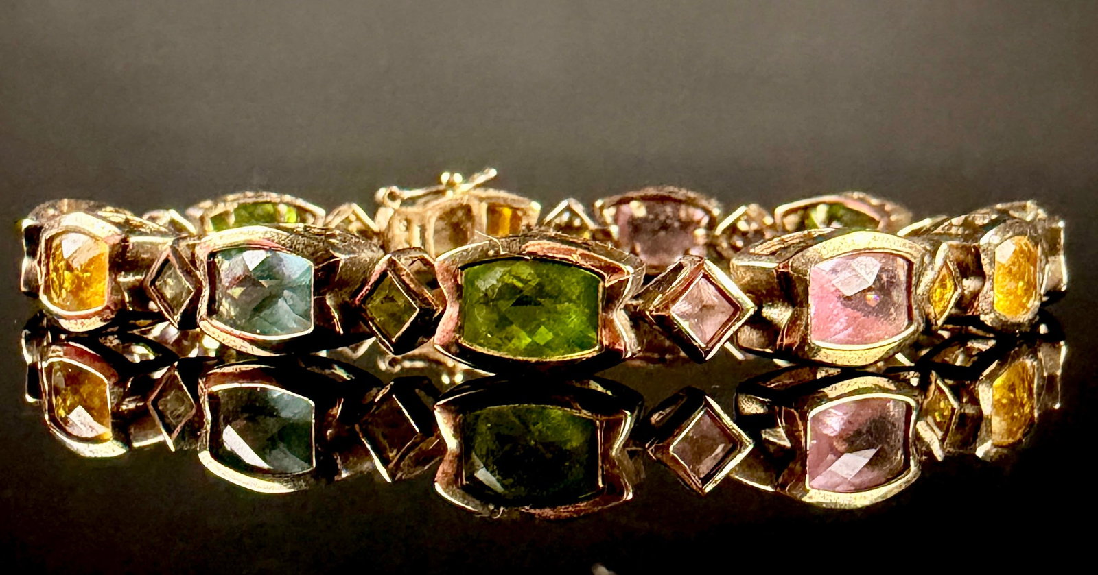 Ross-Simons Multi-Gemstone Vermeil Sterling Silver Link Bracelet: A multi-gemstone link bracelet by Ross-Simons. The piece is crafted from yellow gold-plated sterling silver, known as vermeil. It features a series of articulated links set with faceted rectangular cu