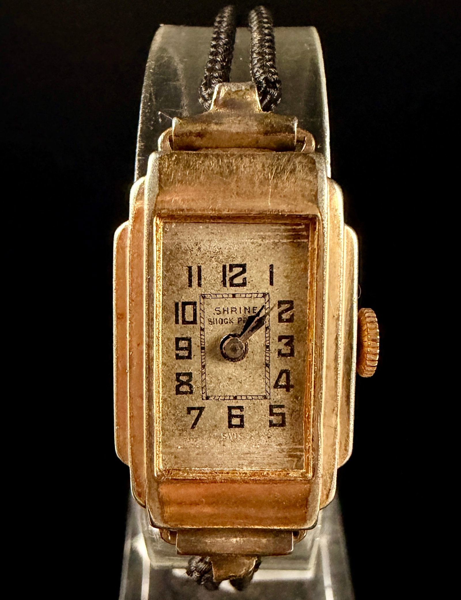 Shrine Watch Co. Art Deco Ladies' Mechanical Cord Watch: This vintage ladies' cocktail watch features a manual wind mechanical movement manufactured by the Shrine Watch Co. The Swiss-made movement is engraved with fifteen 15 jewels and unadjusted. The recta