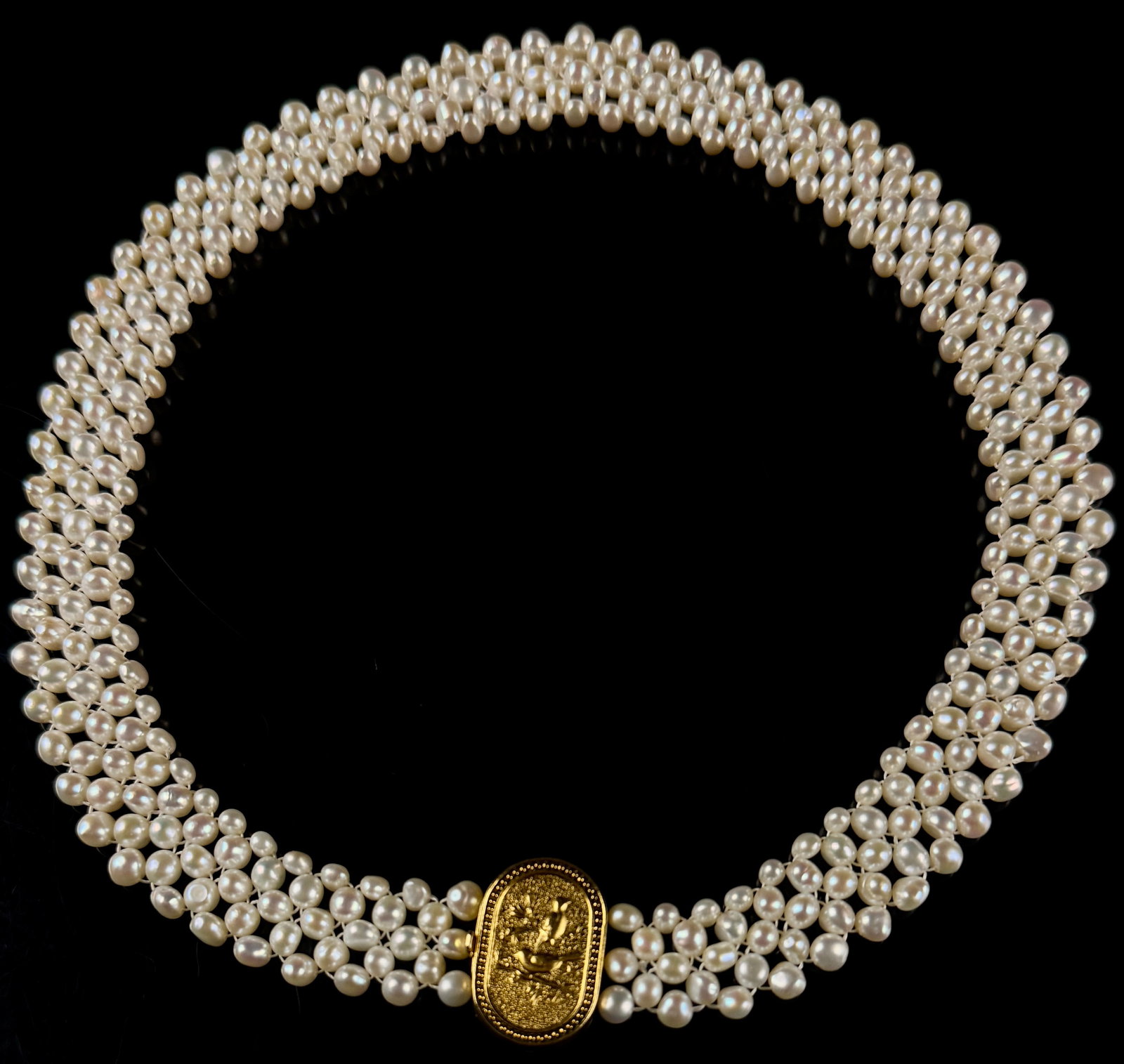 Multilana Three-Strand Cultured Pearl Collar Necklace with Gilt Sterling Silver Bird Motif Clasp: A three-strand cultured pearl collar necklace by the maker Multilana. The necklace is composed of three strands of off-white to cream-colored semi-round to baroque cultured pearls, each measuring appr