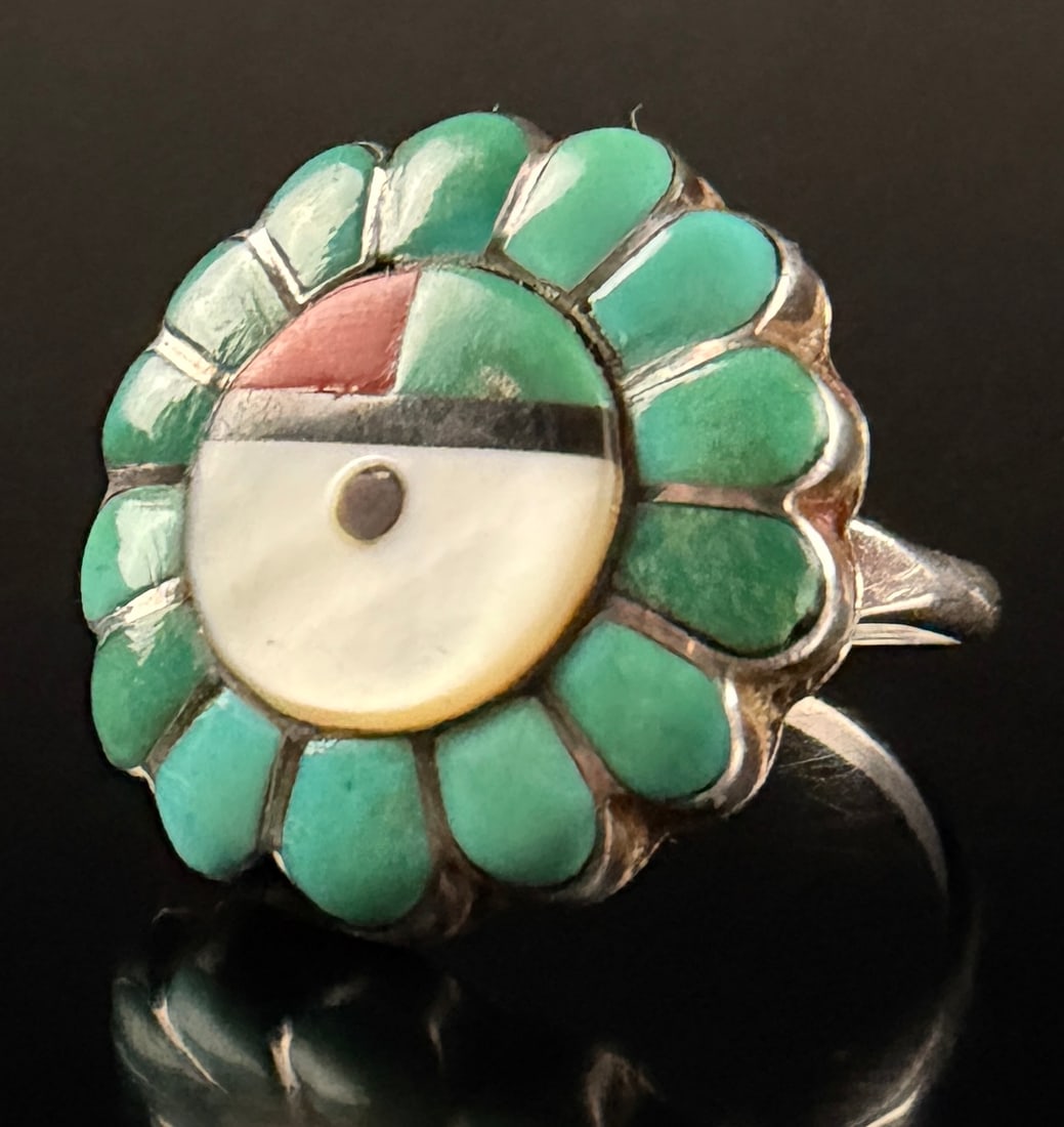 Native American Zuni Leo P. Lukee Sterling Silver Sunface Cluster Ring: A handcrafted sterling silver cocktail ring by Zuni artist Leo P. Lukee. The ring features a central circular multi-stone inlay depicting a traditional Sunface motif, composed of mother of pearl, Medi