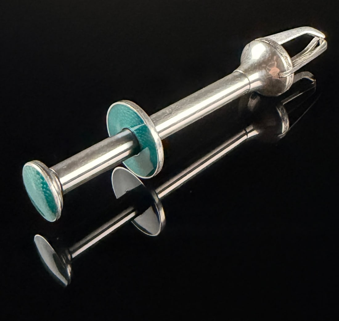 Aksel Scharning Norwegian Silver-Plated and Turquoise Guilloche Enamel Mechanical Pincer: This mid-century mechanical serving pincer is the work of Norwegian designer Aksel Scharning. The tool is constructed from silver-plated metal and features translucent turquoise blue guilloche enamel
