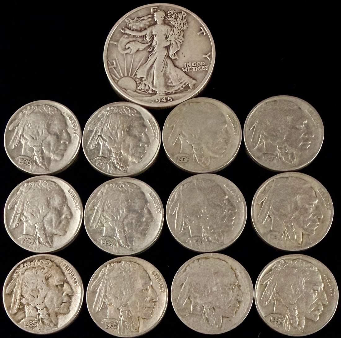 A Collection of US Coins Featuring a 1945 Walking Liberty Half Dollar and Buffalo Nickels: This collection of United States coinage consists of a 1945 Walking Liberty silver half dollar and a group of Buffalo nickels. The half dollar is composed of 90 percent silver and features the Walking