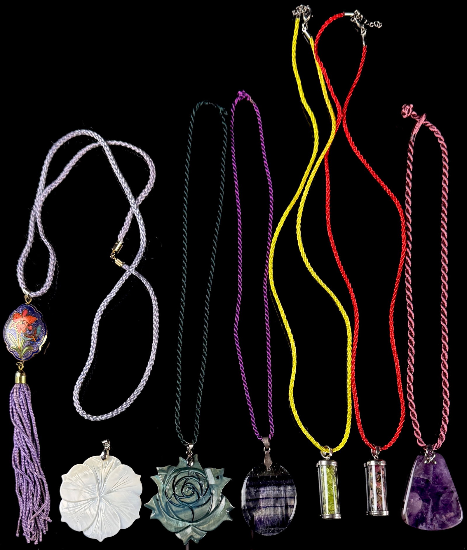 A Collection of Seven Assorted Cloisonn?©, Semi-Precious Stone, and Carved Mother-of-Pearl: This lot features seven necklaces and pendants composed of various materials including semi-precious stones, carved mother-of-pearl, and enamel work. One necklace consists of an oval-shaped pendant wi