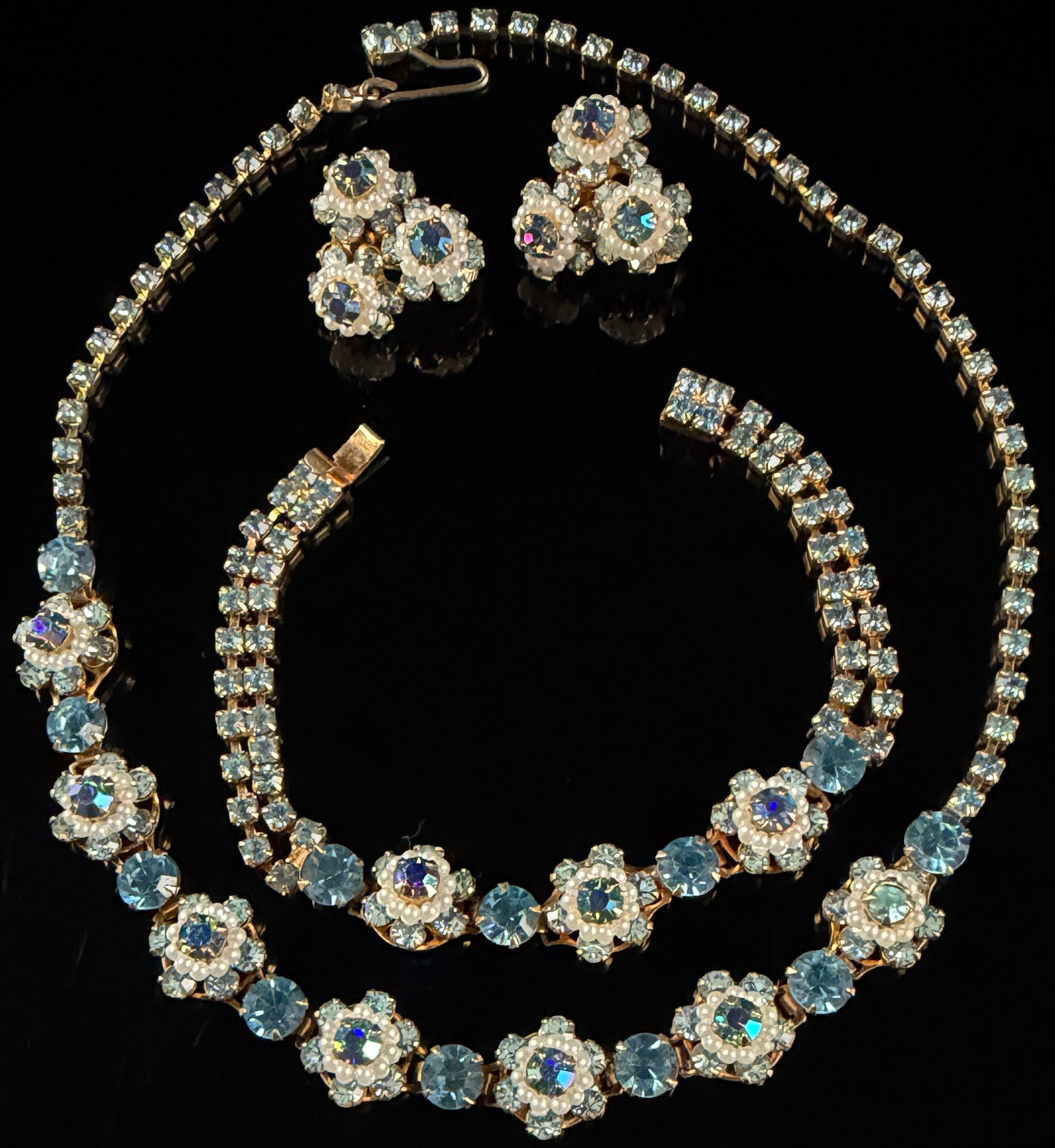 A Vintage Three-Piece Costume Jewelry Parure Attributed to Bogoff: This vintage three-piece costume jewelry parure, attributed to Bogoff based on design characteristics and setting style, includes a necklace, a bracelet, and a pair of clip-on earrings. The set is con