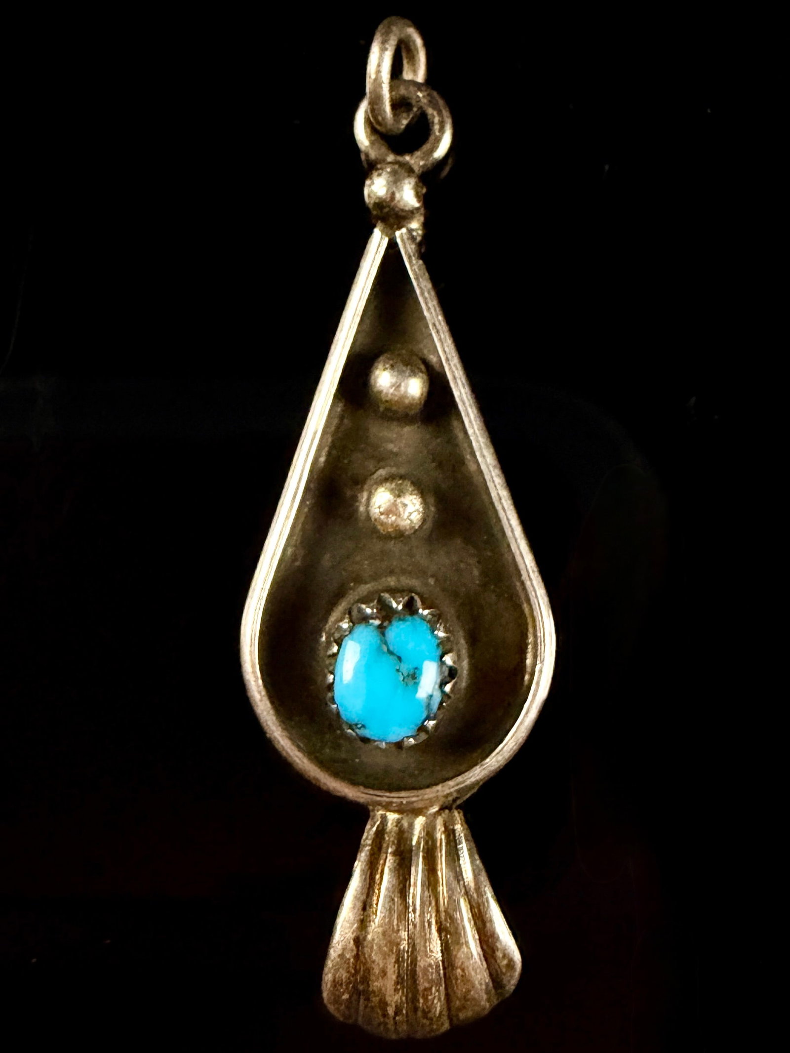 Julia Lynch Navajo Sterling Silver and Turquoise Pendant: This handcrafted Southwestern style pendant is the work of Navajo artist Julia Lynch. The teardrop-shaped piece is constructed of sterling silver and features a single oval turquoise cabochon, measuri