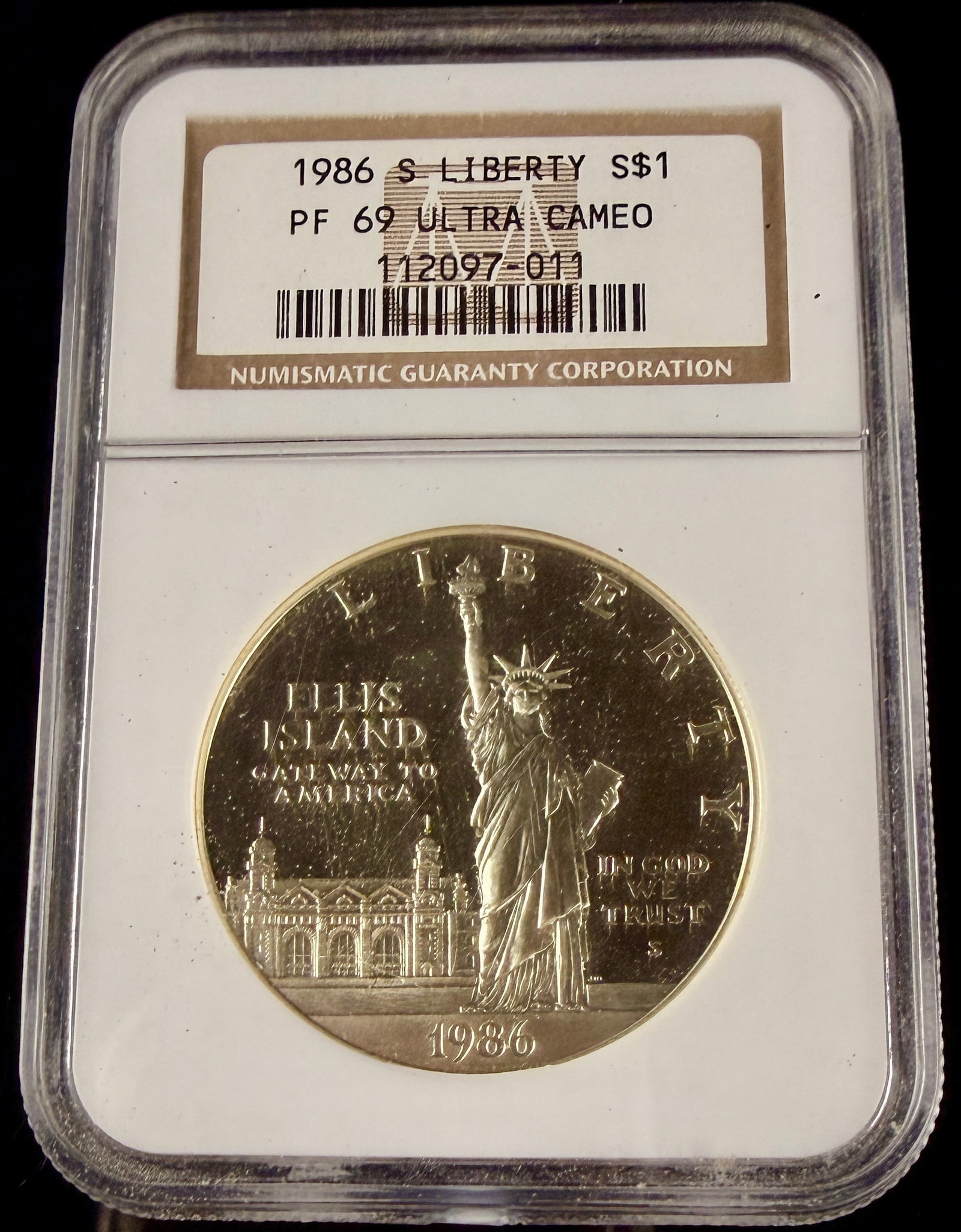 US 1986-S Statue of Liberty Centennial Commemorative Silver Dollar NGC PF 69 Ultra Cameo: This 1986 United States silver dollar is a commemorative issue struck at the San Francisco Mint to honor the centennial of the Statue of Liberty and Ellis Island. The coin is composed of 90% silver an