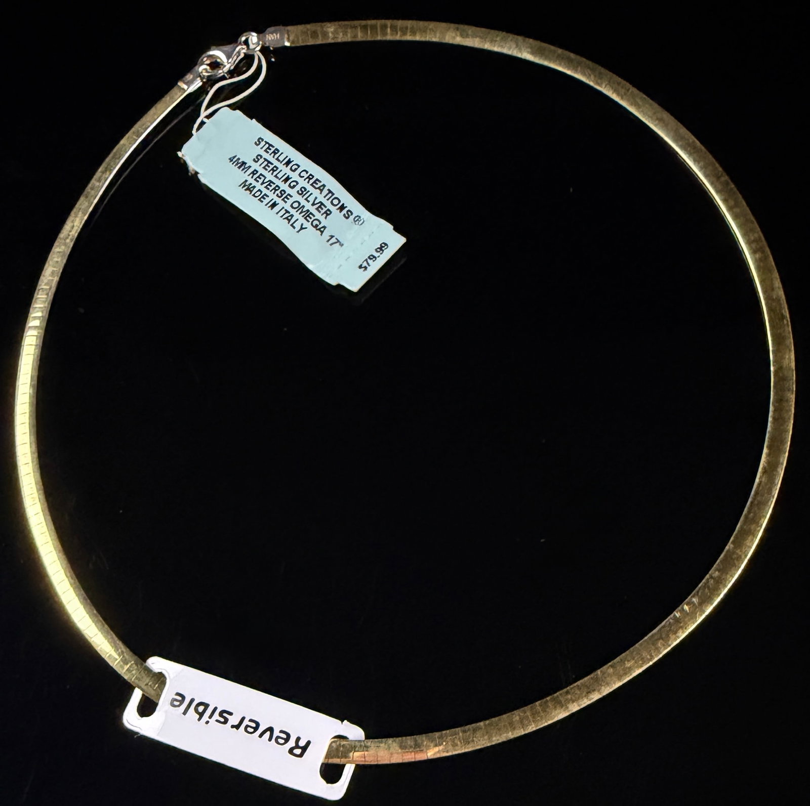 Sterling Creations Reversible Sterling Silver Two Tone Omega Link Necklace: A reversible sterling silver omega link necklace manufactured by Sterling Creations. This semi-rigid collar necklace features a dual-sided design with a polished yellow gold-toned finish on one side a