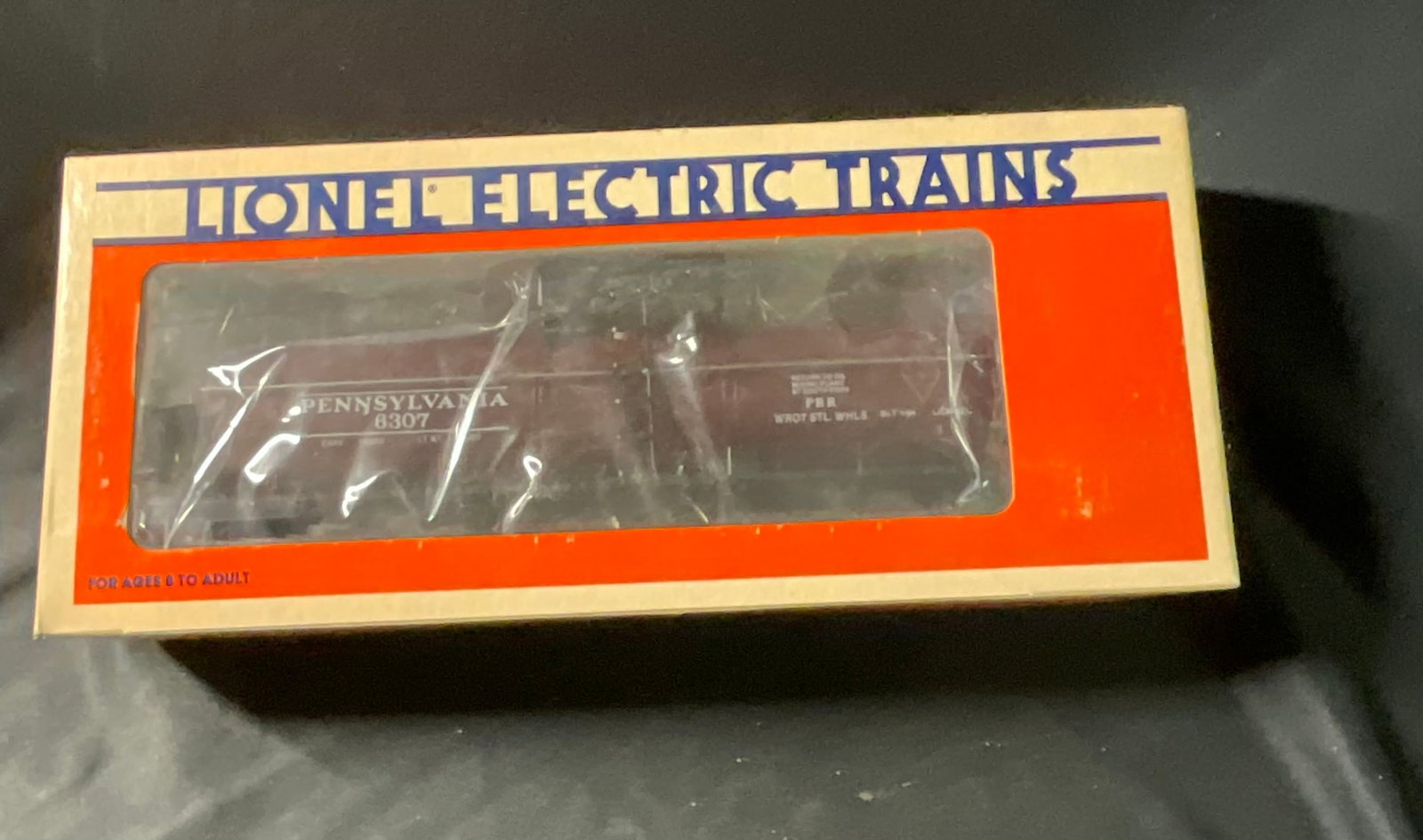 Lionel Pennsylvania Single-Dome Tank Car 6-6307 with Original Box: A Lionel O-gauge model train car representing a Pennsylvania Railroad single-dome tank car, model number 6-6307. Manufactured during the Fundimensions era, the car features a plastic body finished in 