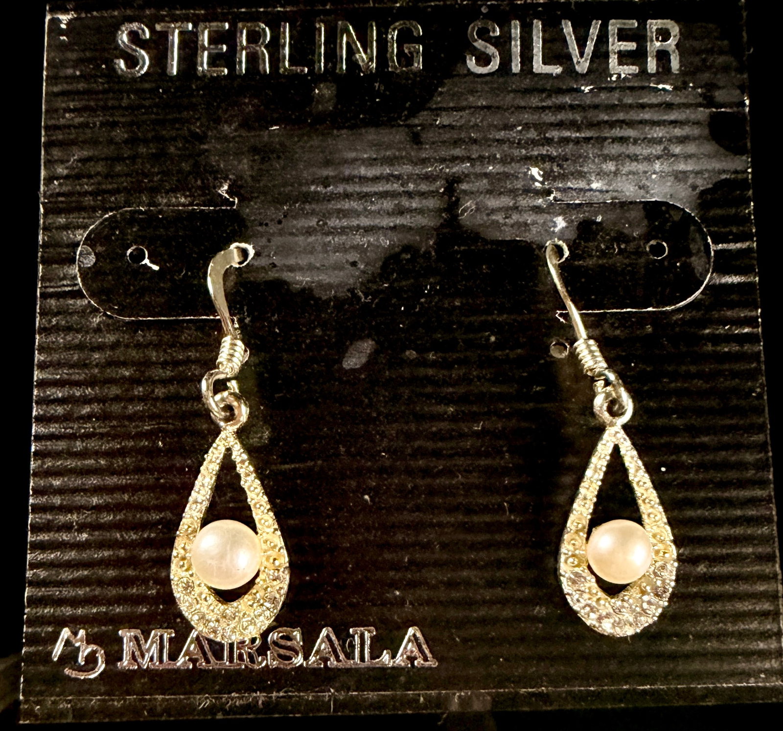 A Pair of Marsala Sterling Silver Pearl and Colorless Stone Teardrop Drop Earrings: A matched pair of teardrop drop earrings by the brand Marsala. Each earring features a sterling silver open-work teardrop frame pav?©-set with small round-cut colorless stones. A single round white p