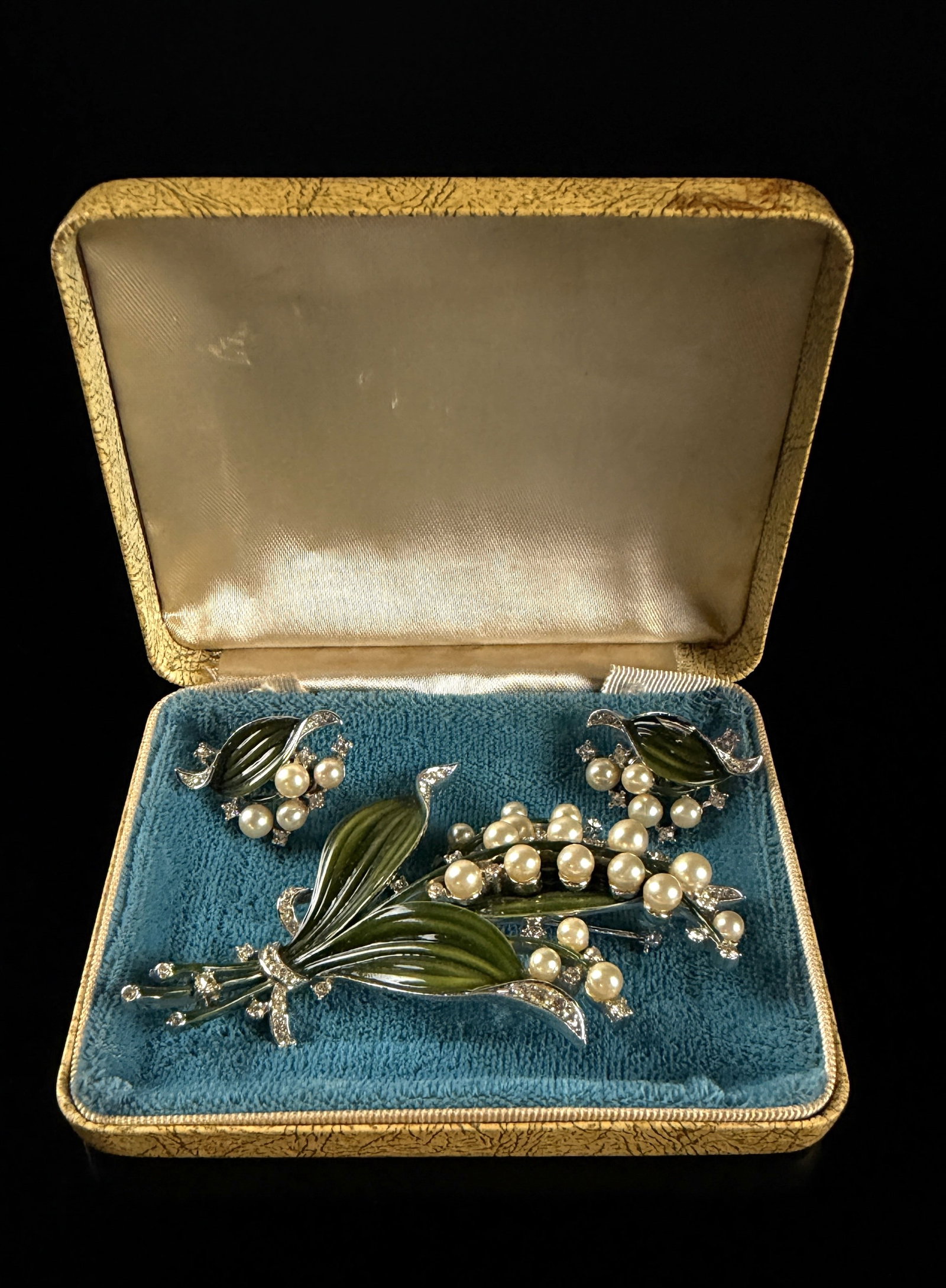 A Crown Trifari Alfred Philippe Lily of the Valley Enamel and Simulated Pearl Demi-Parure: Designed by Alfred Philippe for Trifari. This vintage costume jewelry demi-parure by Trifari features a botanical Lily of the Valley motif and consists of a large brooch and a pair of matching clip-on