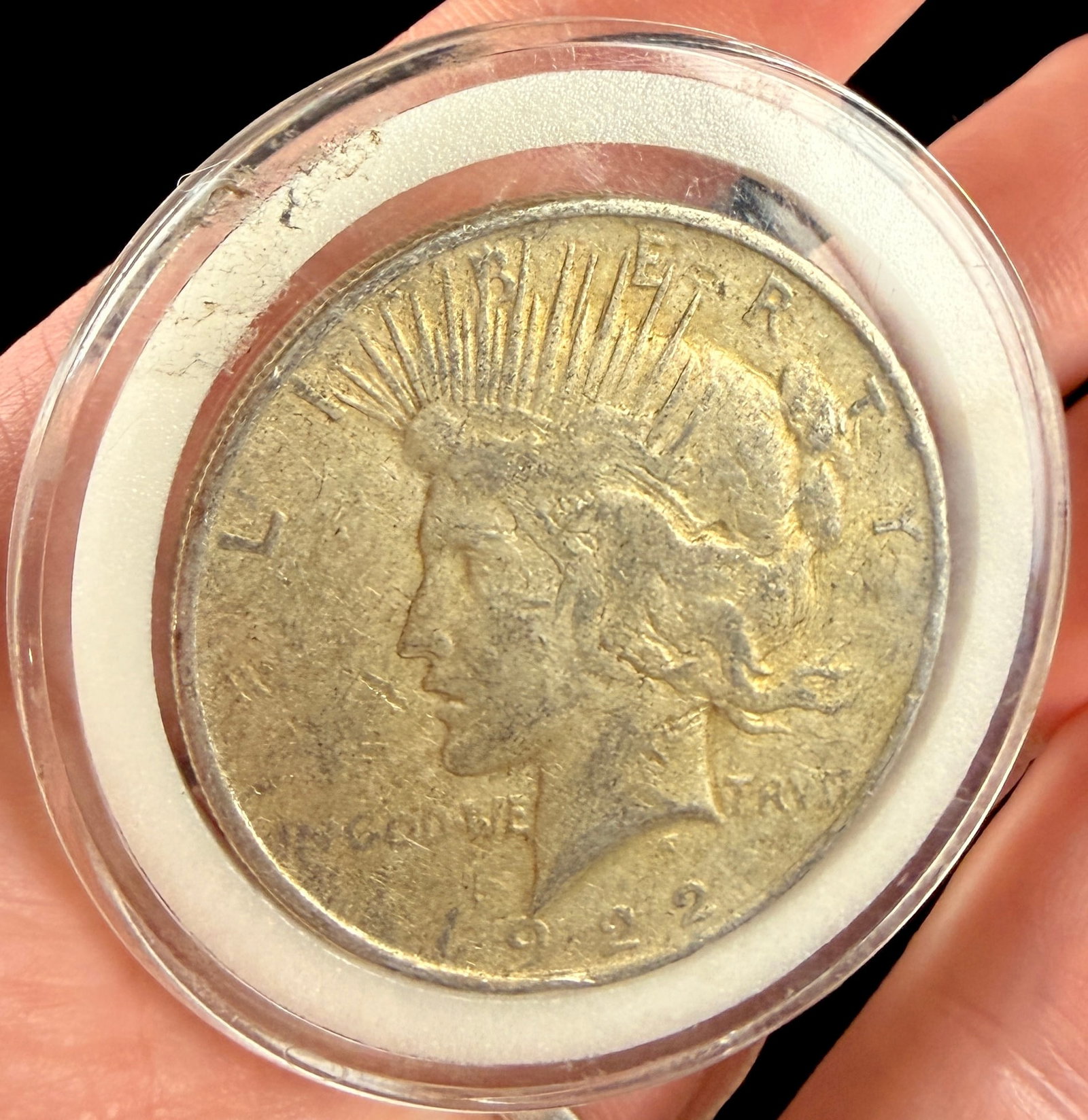 US 1922 Peace Silver Dollar: US 1922 Peace silver dollar struck at the Philadelphia mint. This coin is composed of .900 fine silver and features a reeded edge. The obverse displays the Peace dollar design with inscriptions LIBERT