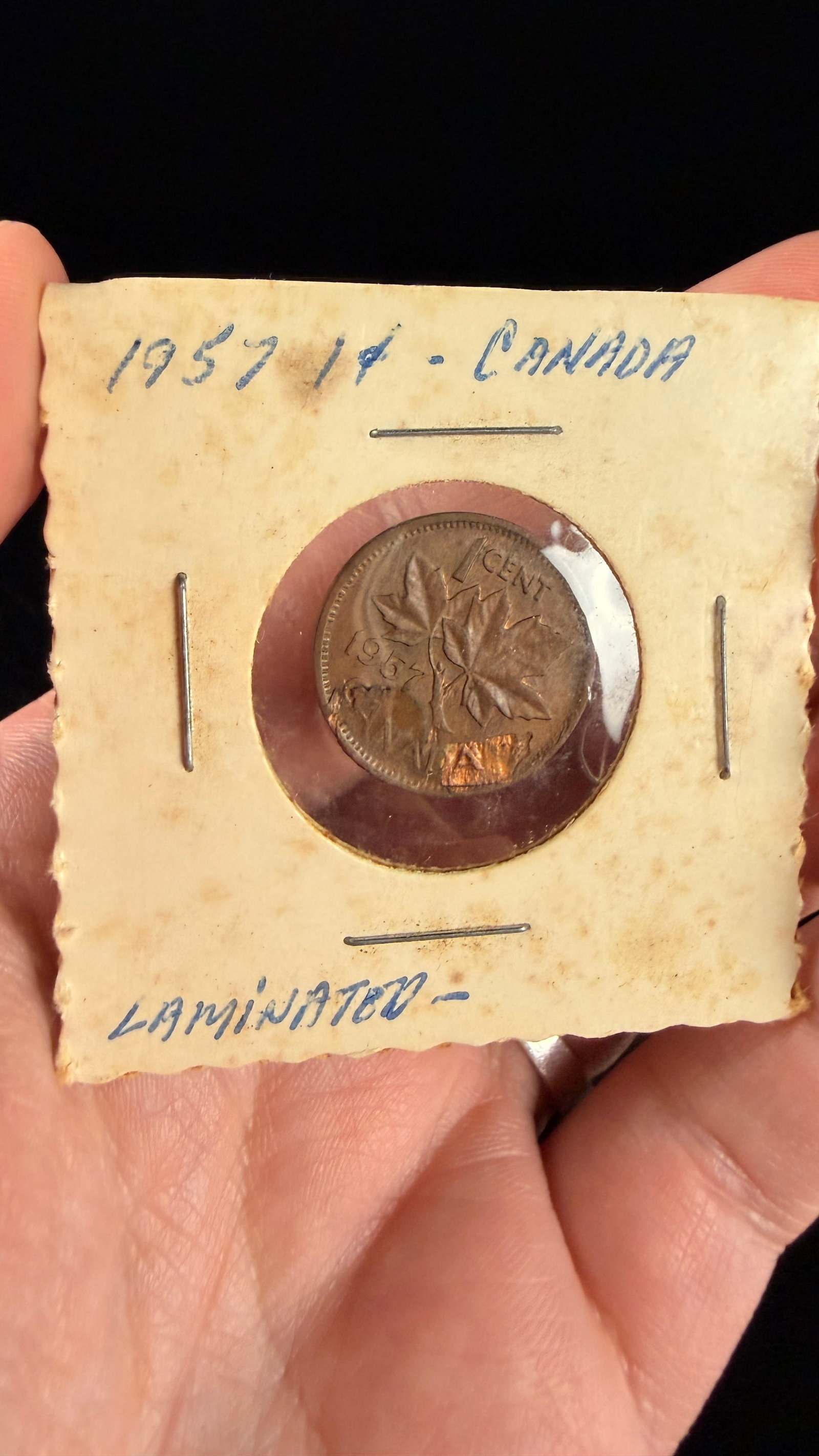 1957 Canada 1 Cent Bronze Coin with Reverse Lamination Error: This 1957 Canadian 1-cent coin is struck in bronze and features the laureate bust of Queen Elizabeth II on the obverse with the legend ELIZABETH II DEI GRATIA REGINA. The reverse displays the maple