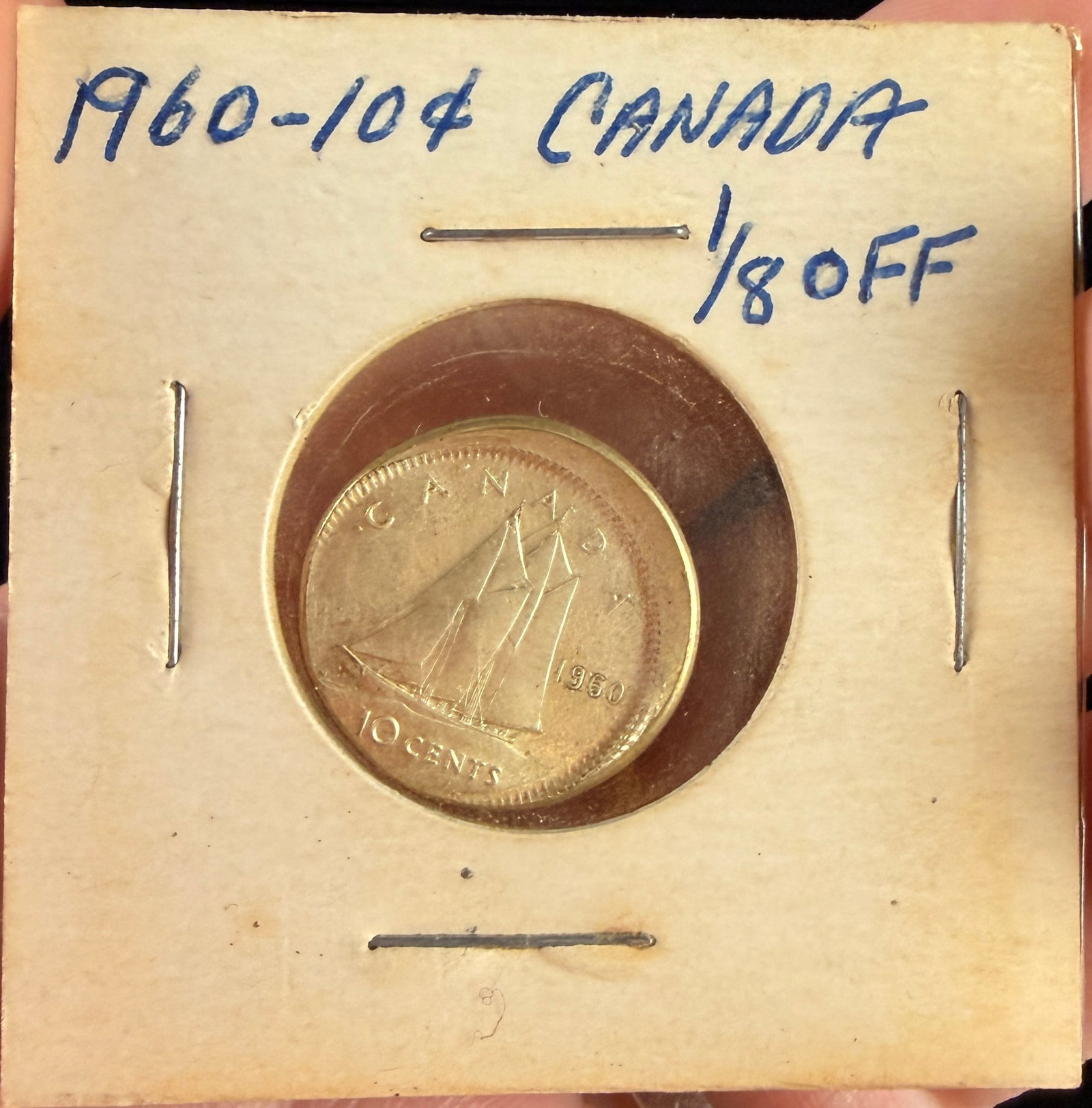 1960 Canada Silver 10-Cent Coin Off-Center Strike Error: A 1960 Canadian 10-cent silver coin featuring a notable off-center strike manufacturing error. The coin is struck in 80 percent silver. The obverse features the Queen Elizabeth II laureate portrait,
