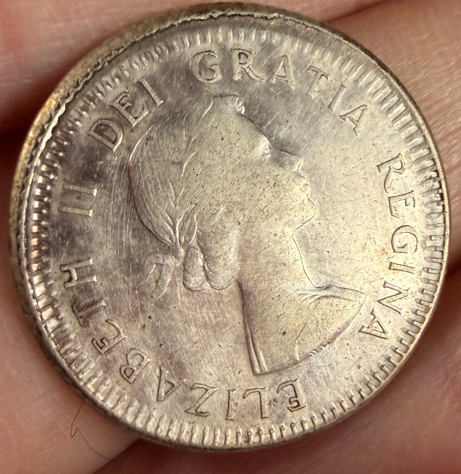 CA 1959 10 Cents Elizabeth II Silver Coin: 1959 Canadian 10-cent coin struck in 80 percent fine silver. The obverse features the laureate portrait of Queen Elizabeth II and the circumscribed legend ELIZABETH II DEI GRATIA REGINA. The reverse