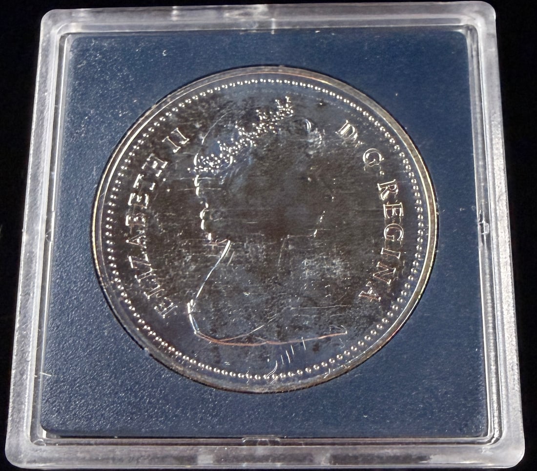 1981 Canada Nickel Dollar Canadian Pacific Railway Centennial: 1981 Canadian 1-dollar commemorative coin struck in nickel. The obverse features the Arnold Machin effigy of Queen Elizabeth II with the circumscribed legend ELIZABETH II D G REGINA. The reverse displ