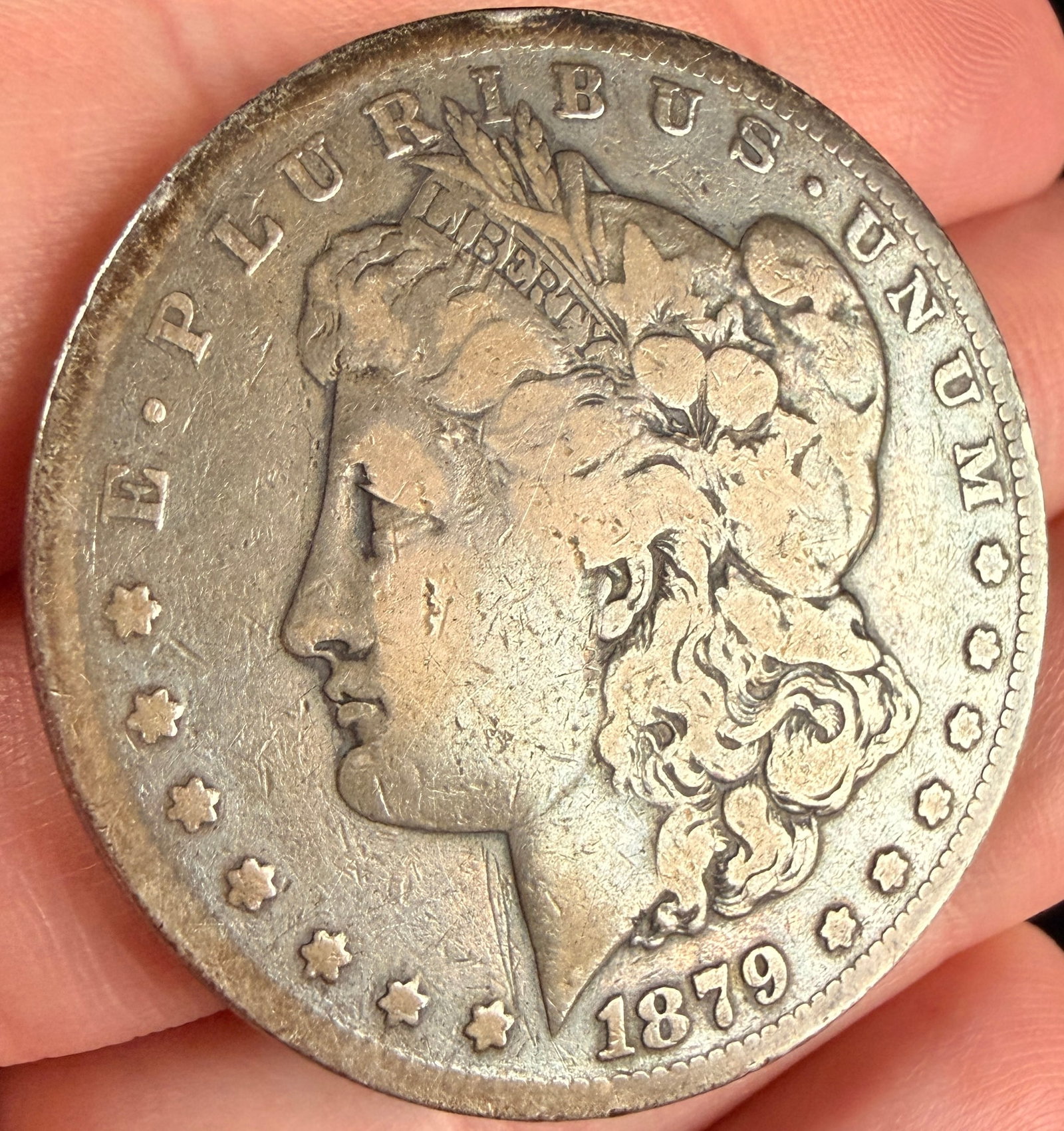 1879-S US Morgan Silver Dollar: US Morgan silver dollar struck at the San Francisco Mint. The coin features the Morgan head obverse and the eagle reverse. The metal composition is 90% silver. The S mint mark is located on the revers
