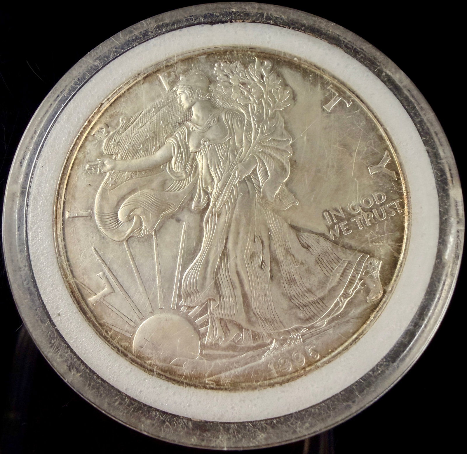 1996 US American Silver Eagle One Dollar 1 oz Fine Silver Coin: This 1996 United States American Silver Eagle bullion coin is struck in one troy ounce of .999 fine silver. The obverse features the Walking Liberty design with inscriptions for LIBERTY, IN GOD WE TRU