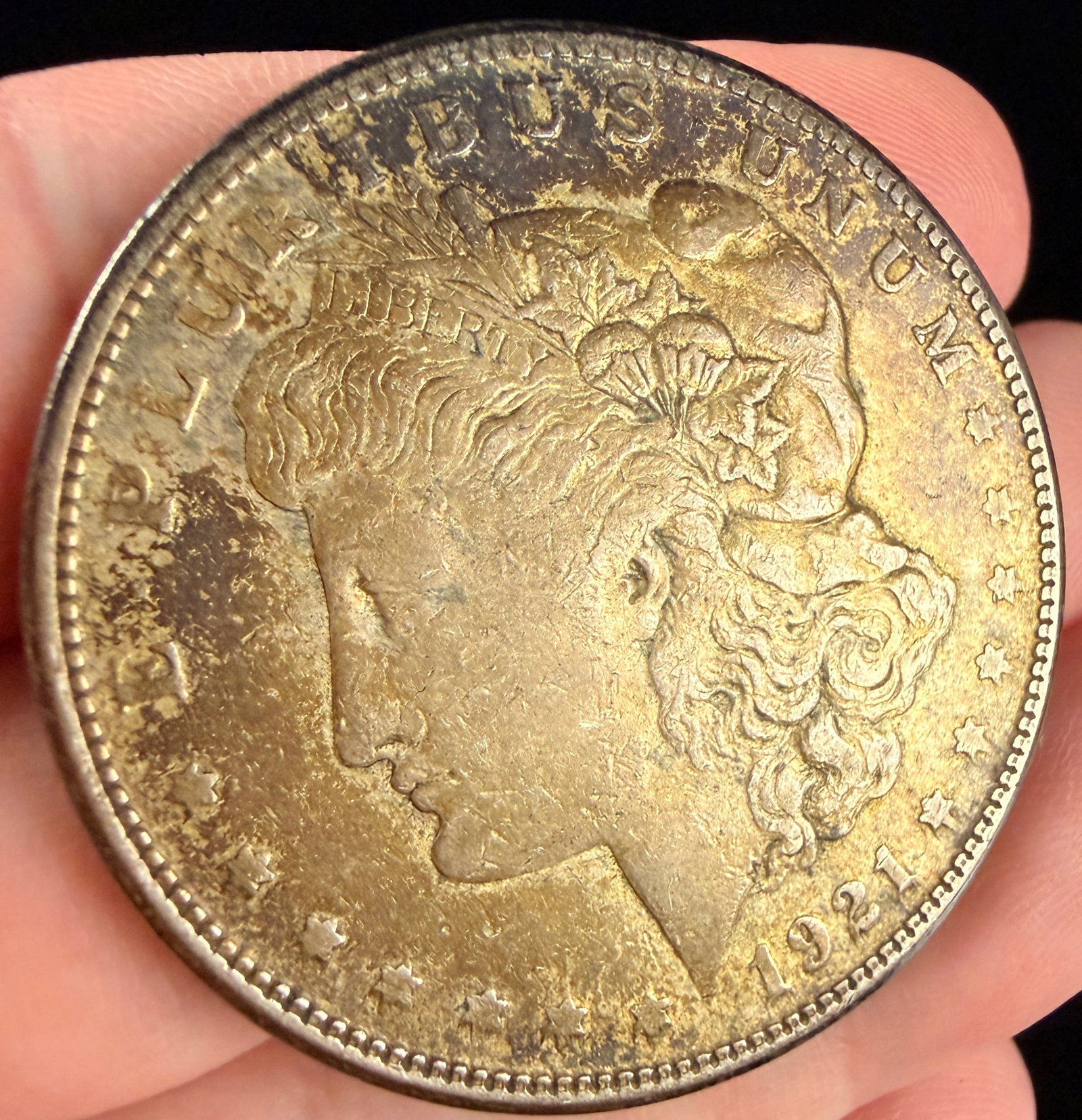 1921-S US Morgan Silver Dollar: This 1921 US Morgan Silver Dollar was struck at the San Francisco Mint, as indicated by the S mint mark located on the reverse below the wreath. The coin is composed of 90% silver and 10% copper. The 