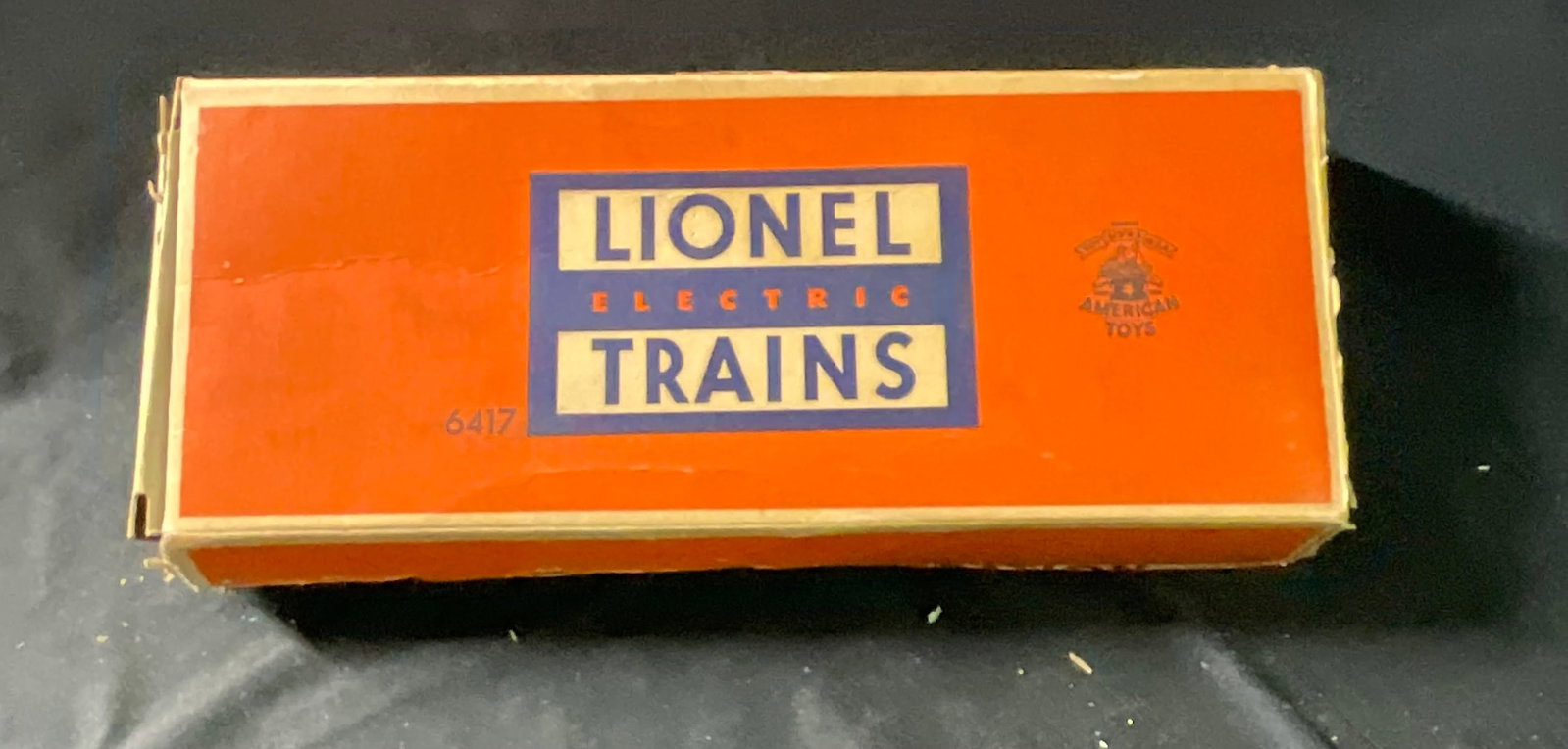 Lionel No. 6417 Pennsylvania N5c Porthole Caboose with Original Box: This Lionel Corporation O-gauge model train car is a No. 6417 Pennsylvania N5c porthole caboose produced circa 1953. The caboose features a molded tuscan red plastic body shell with white heat-stamped