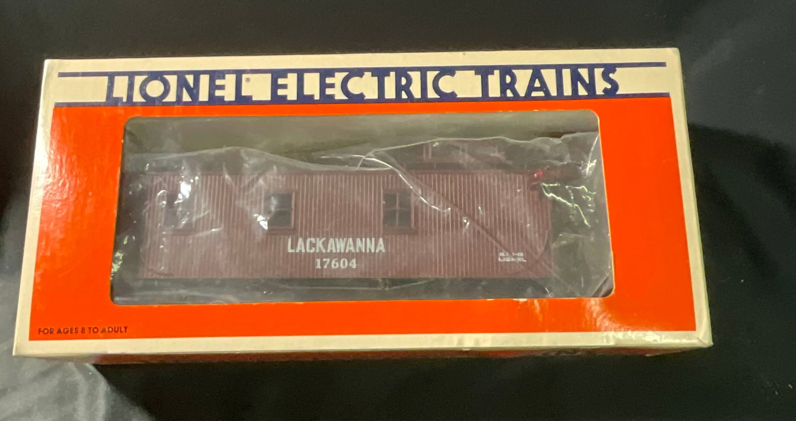 Lionel 6-17604 Delaware Lackawanna and Western Standard O Caboose in Original Box: This is a Lionel O gauge model train caboose, road number 17604, manufactured by Lionel Trains, Inc. of Mt. Clemens, Michigan. The car represents the Delaware, Lackawanna and Western railroad and feat